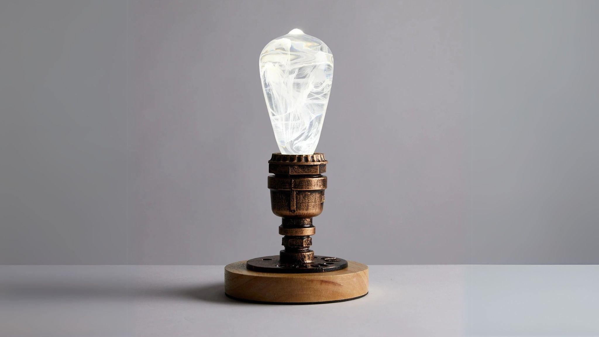 EP Light - Snow bulb with handcrafted resin design and calming winter-inspired glow on rustic wooden base.