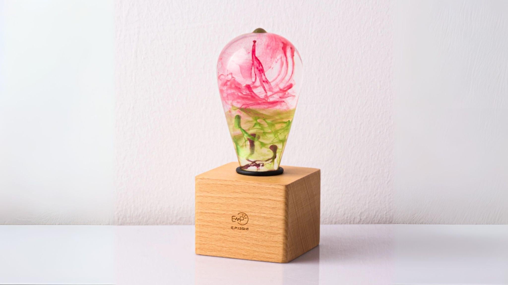 EP Light - Coral bulb with vibrant pink and green eco-resin design on wooden base, handcrafted and energy-saving LED.