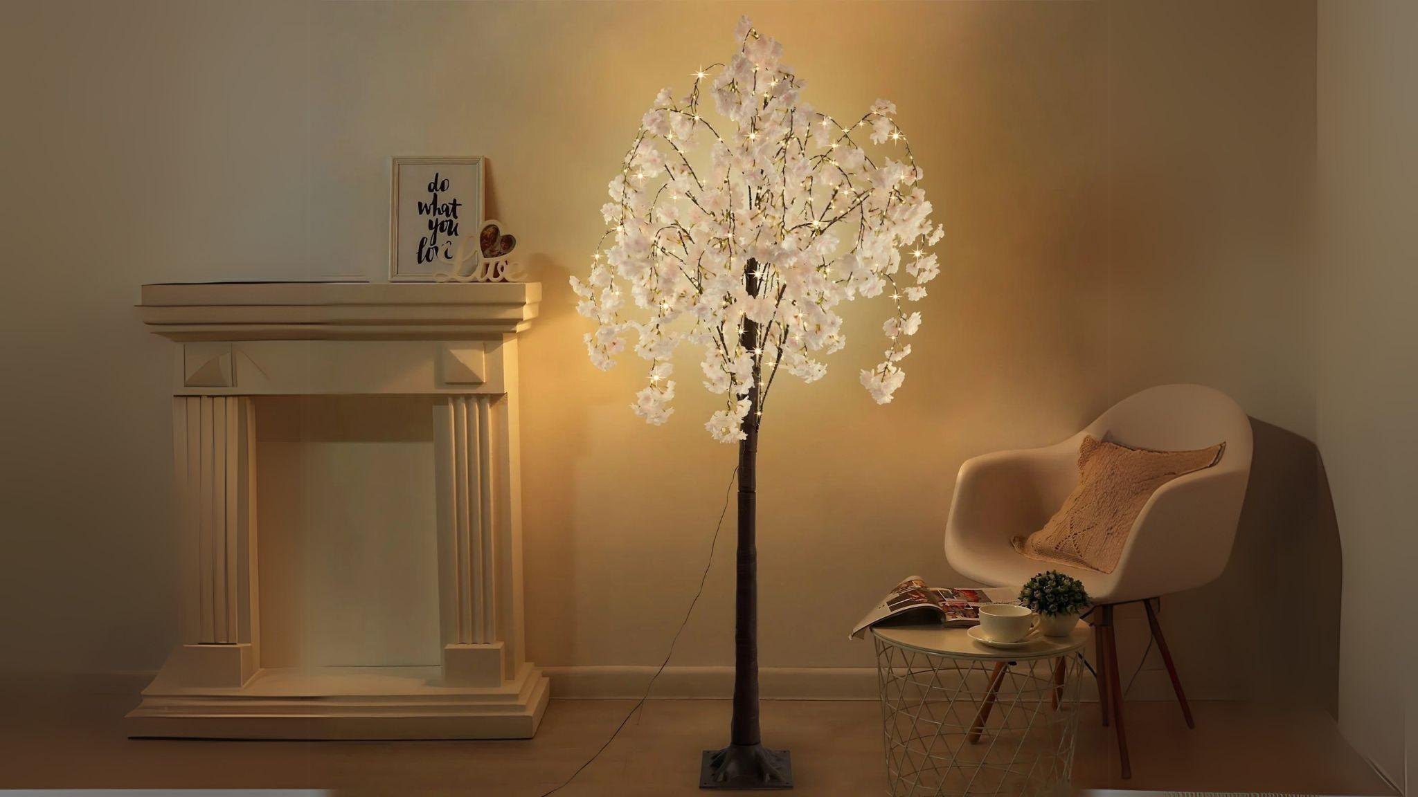 Enchanting LED Cherry Blossom Tree (5.9ft) with warm fairy lights brightening indoor living spaces elegantly.