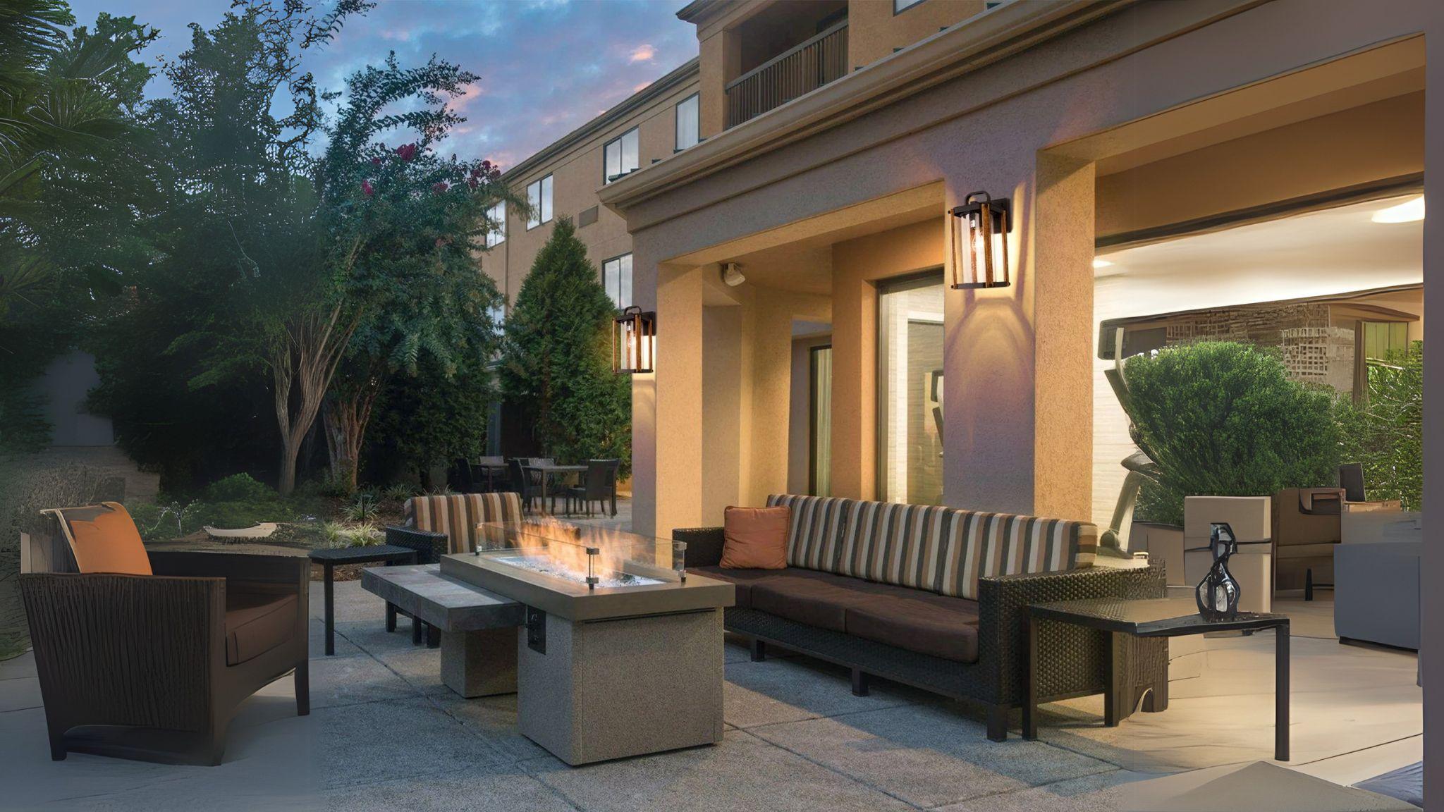 Outdoor Wood Grain Porch Lights illuminating a stylish outdoor seating area with warm, inviting glow at dusk.
