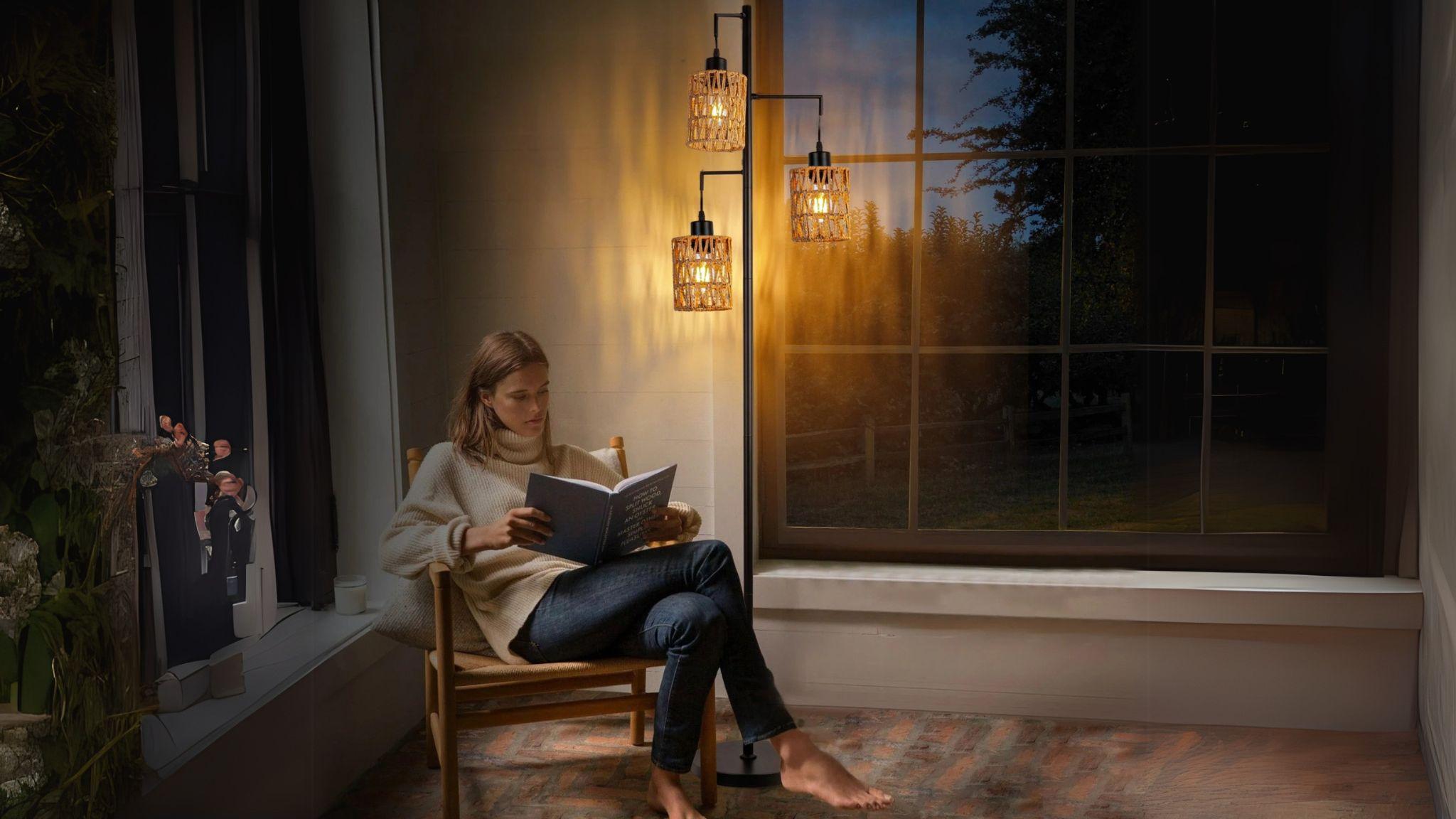 Woman reading by warm light of Boho Rattan Floor Lamp with woven shades in cozy living room at dusk