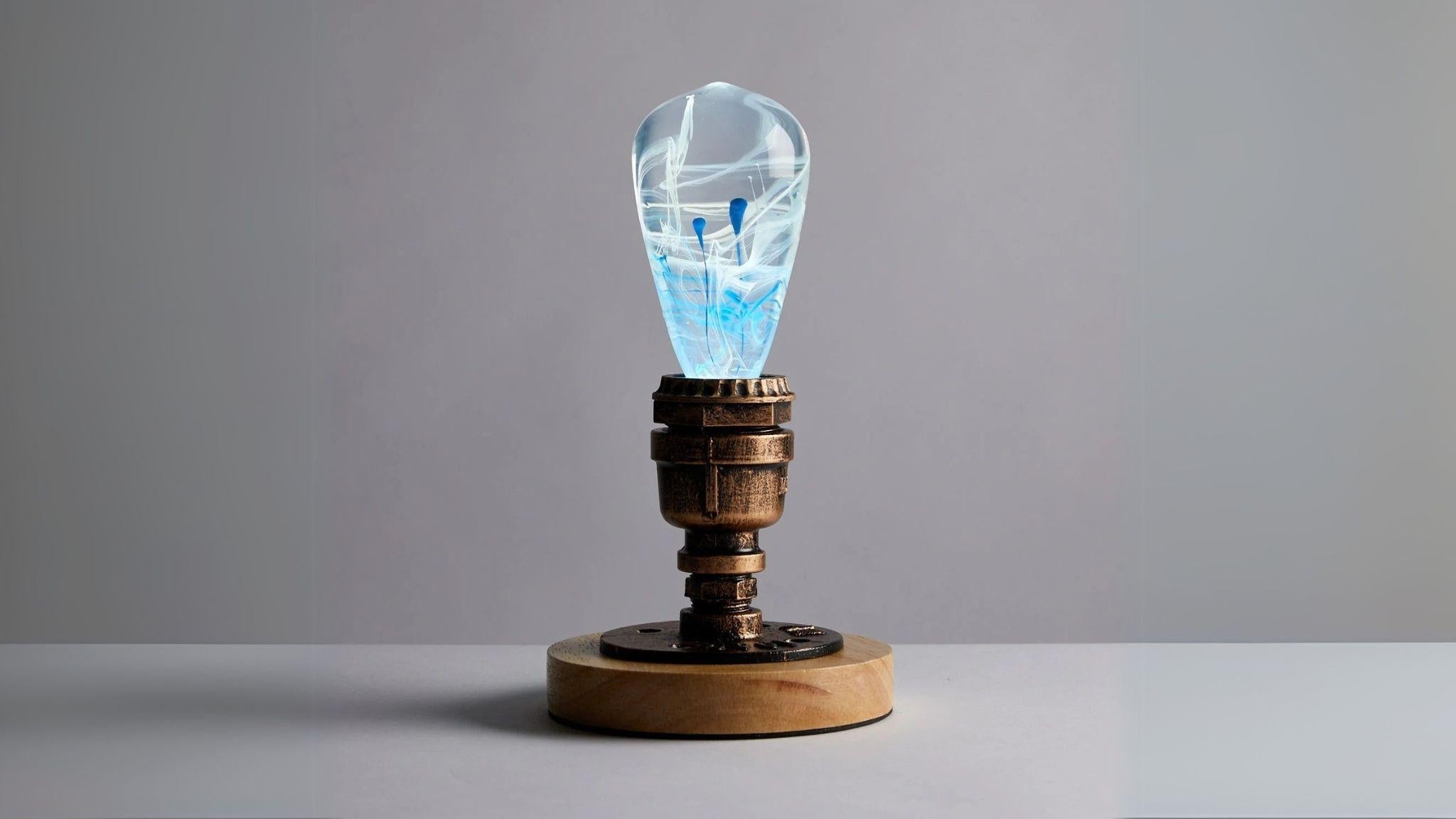 EP Light - Blue Drop handcrafted electric blue resin LED bulb on rustic metal and wood base for unique ambient lighting.