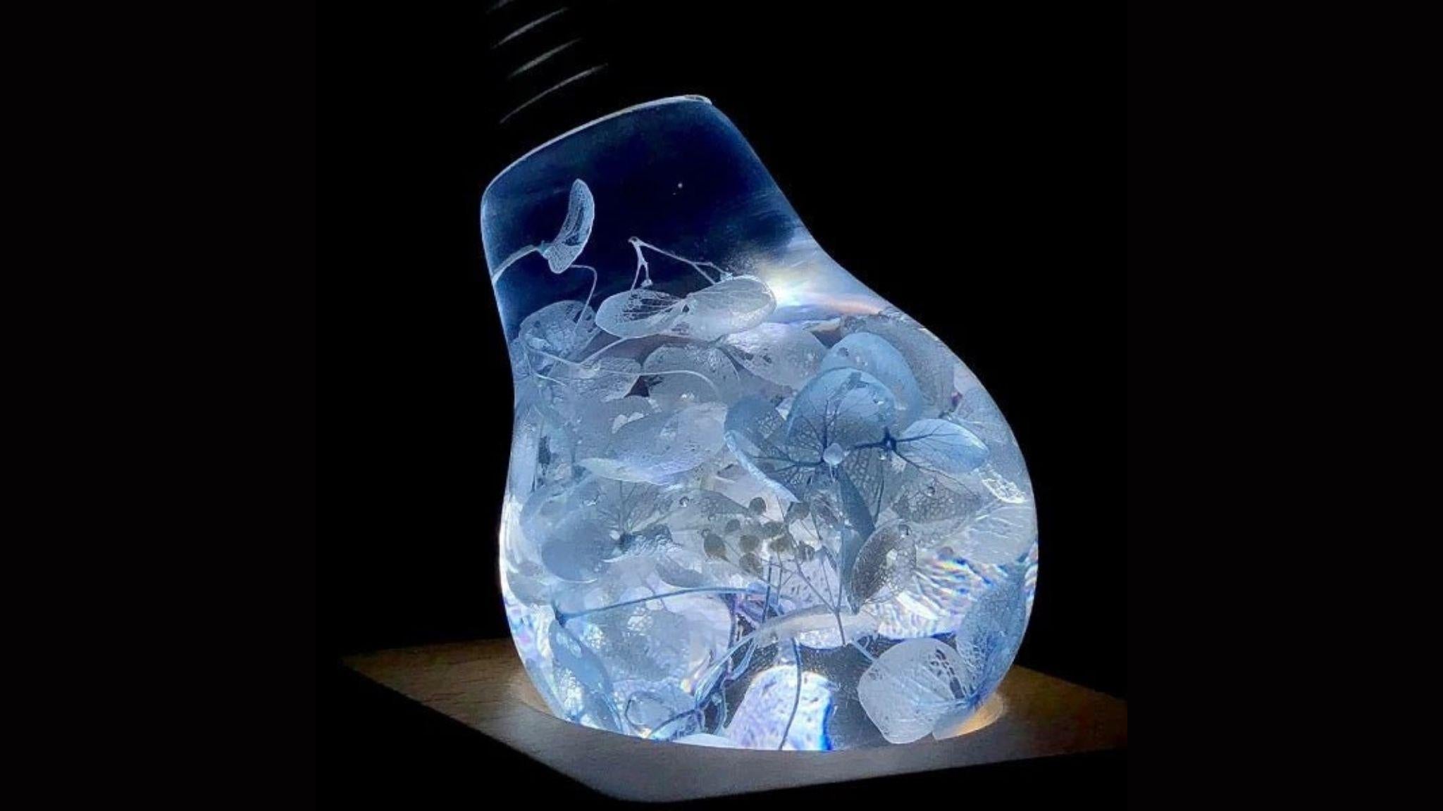 EP Light- Blue Hydrangea bulb glowing with unique blue floral resin design in an energy-saving LED light bulb.