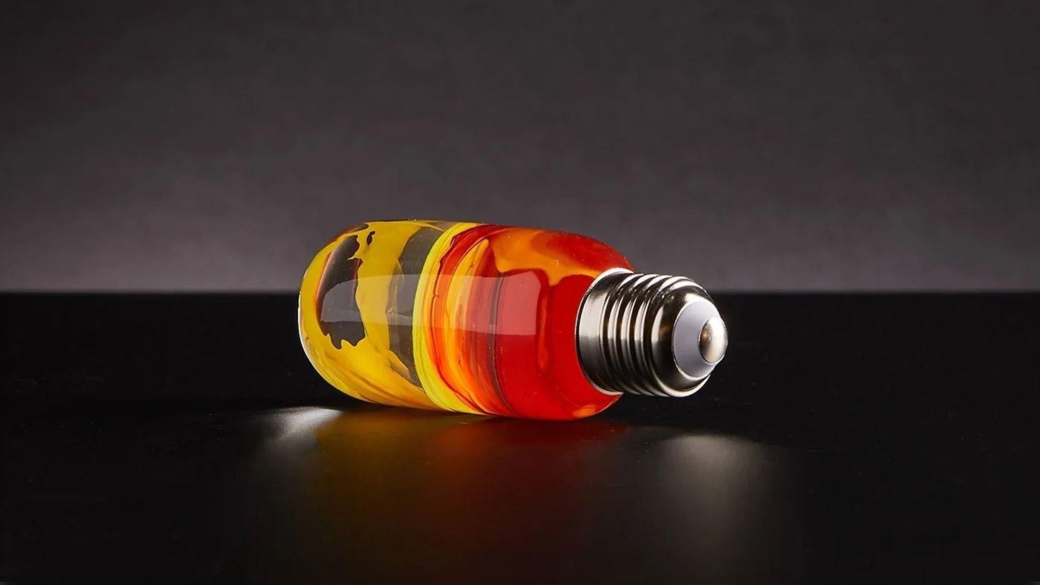 EP Light - Flame bulb glowing with warm amber tones in a handcrafted, eco-resin design for unique ambiance.