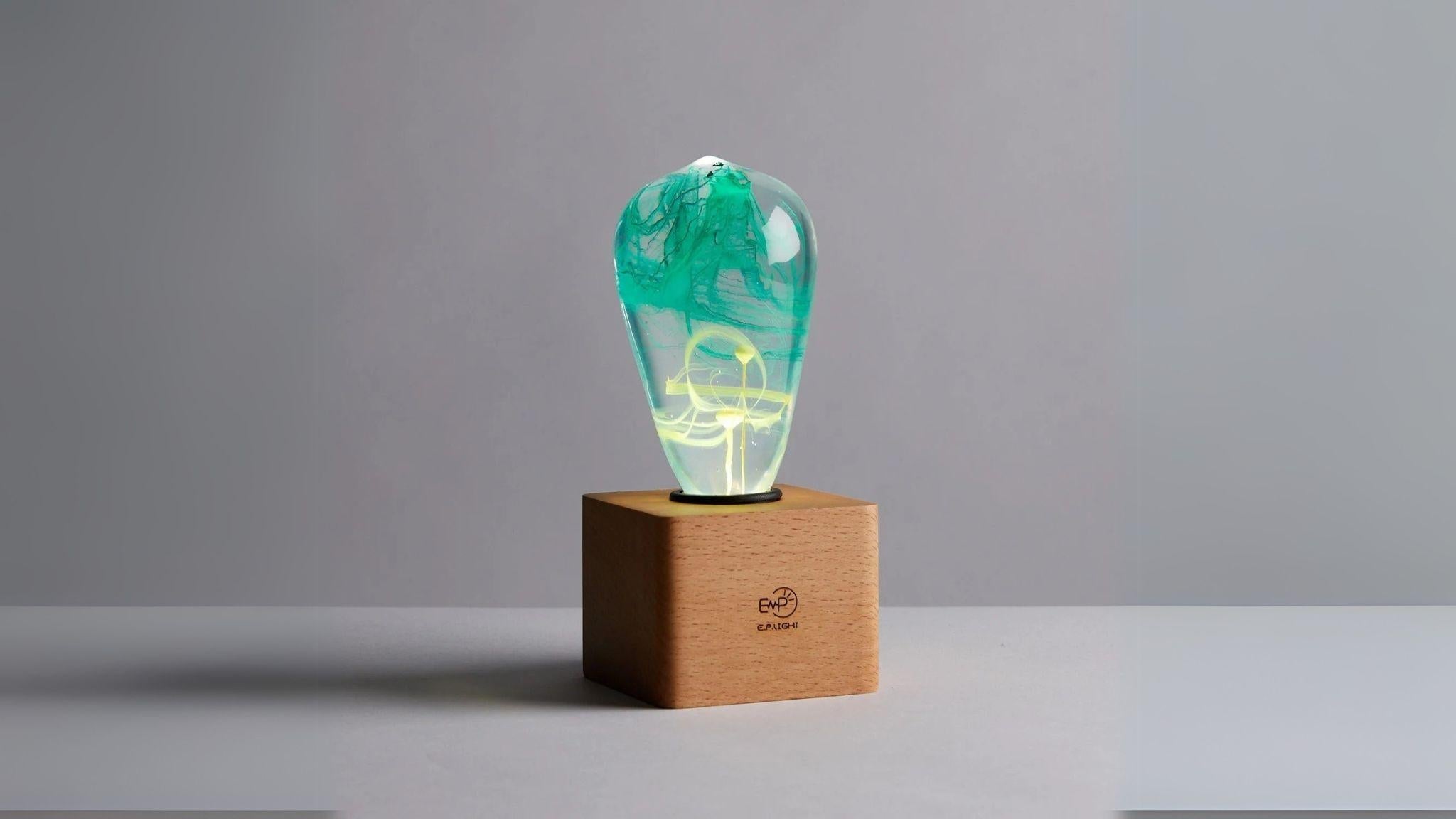 EP Light - Mind lamp with unique green resin design on wooden base illuminating calm and creativity.