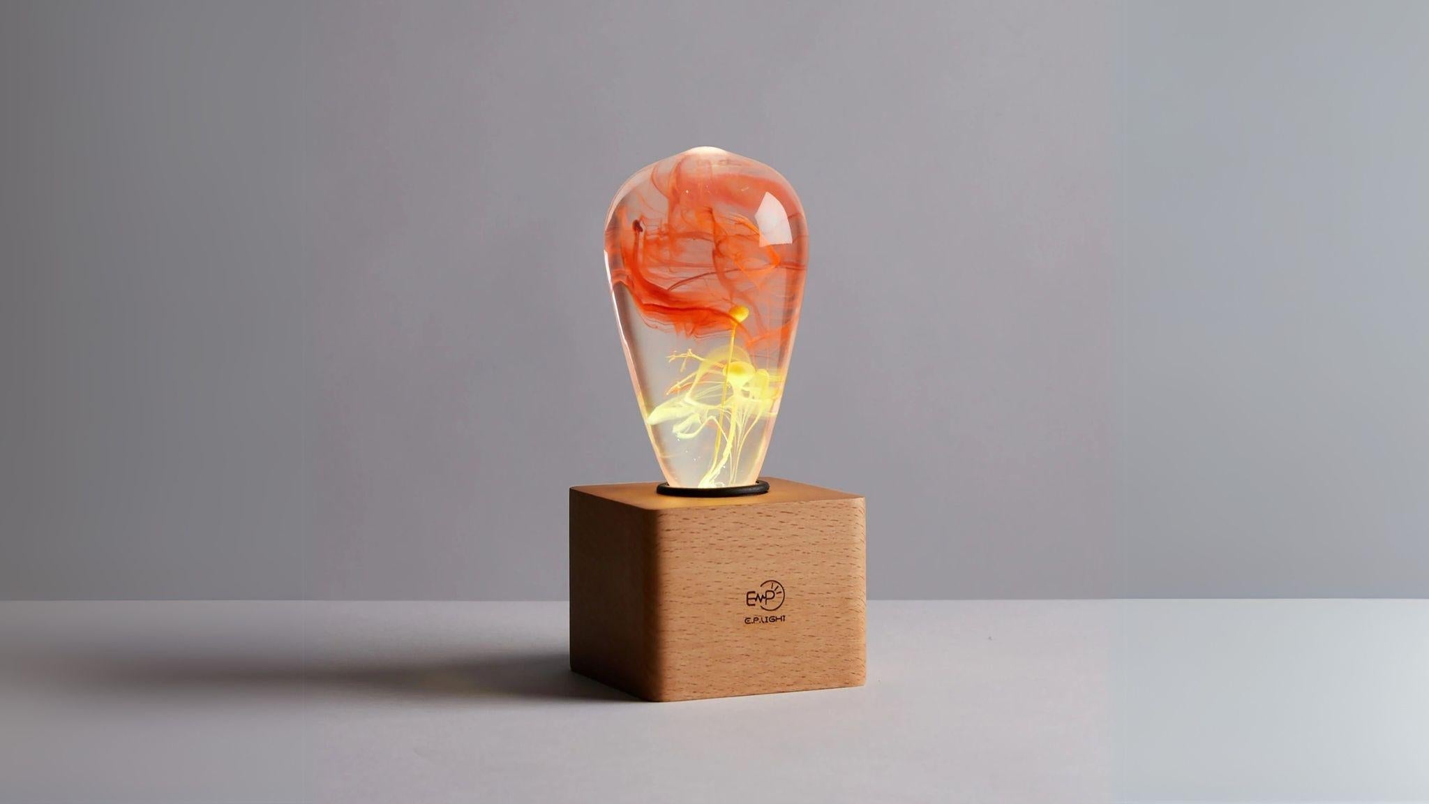 EP Light - Solar Corona handcrafted eco-resin LED lamp with unique solar halo-inspired glow on wooden base.