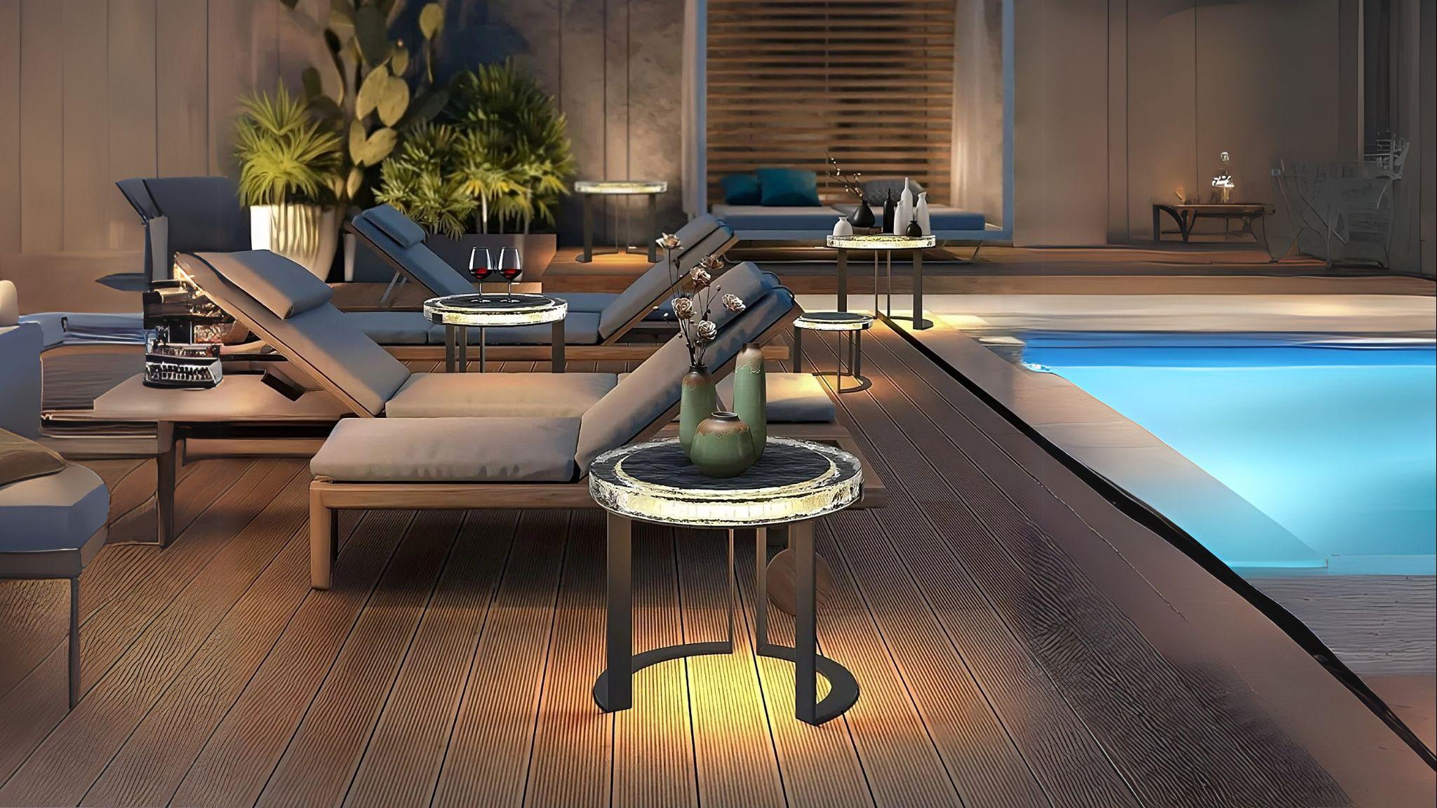 Solar Glow LED Garden Table glowing warmly by poolside, adding stylish ambiance to outdoor patio at night.