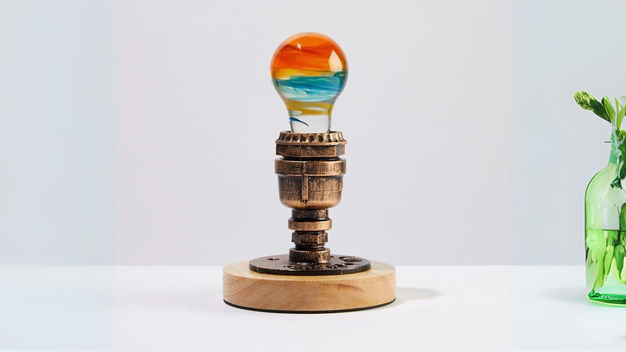 Unique handcrafted EP Light - Solar System bulb with vibrant colors on vintage-style wooden and metal base.