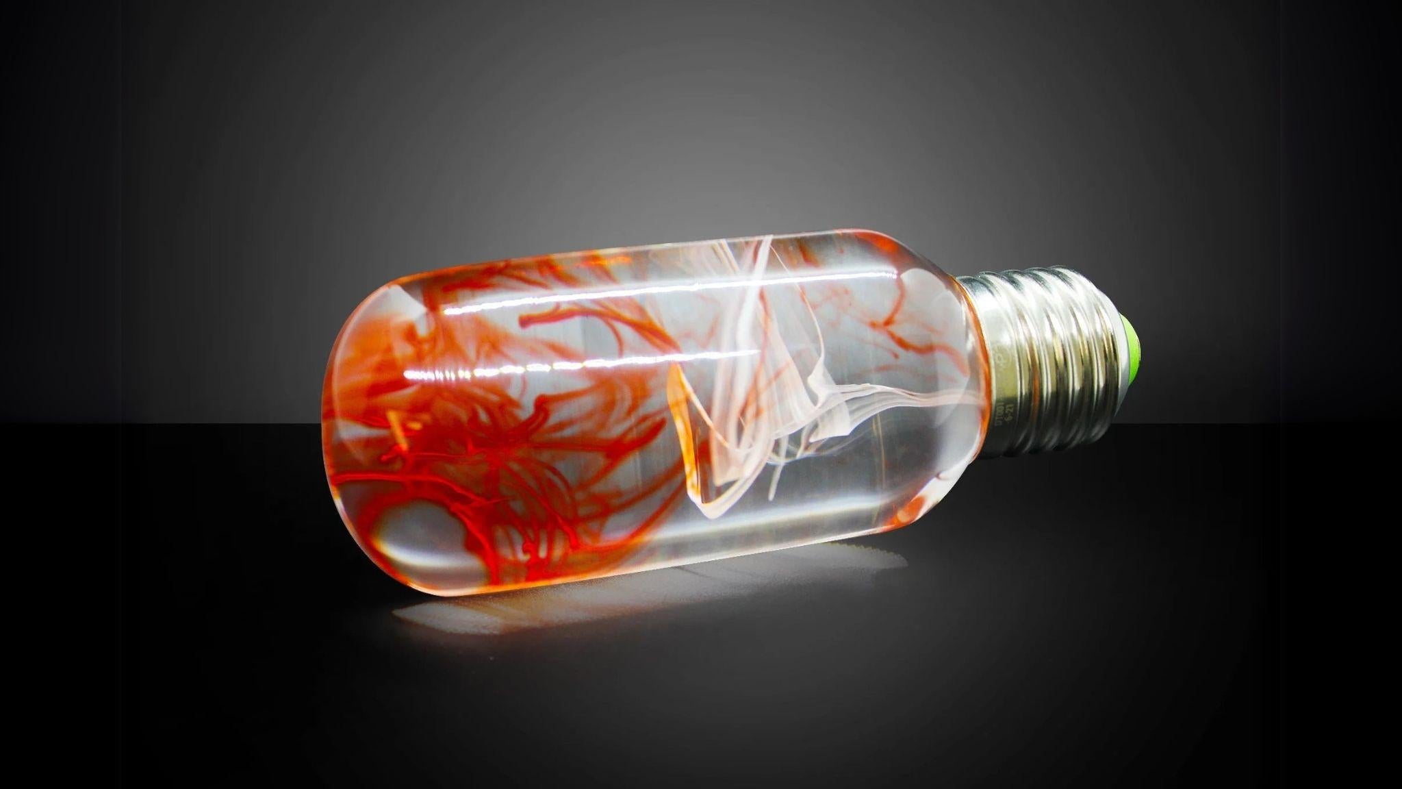 EP Light - Tango bulb with unique orange swirl design, eco-resin, energy-saving, drop-resistant, fits E26/E27 lamp bases.