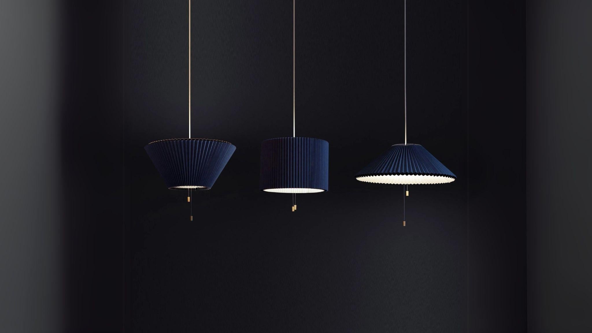 Shape Changing Pendant Lamp in blue shown in three distinct origami shapes with warm LED glow for modern home lighting.