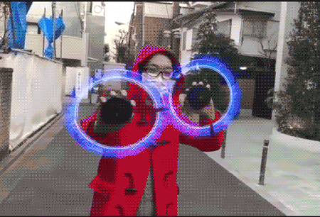 Person using 3D hologram light in street performance