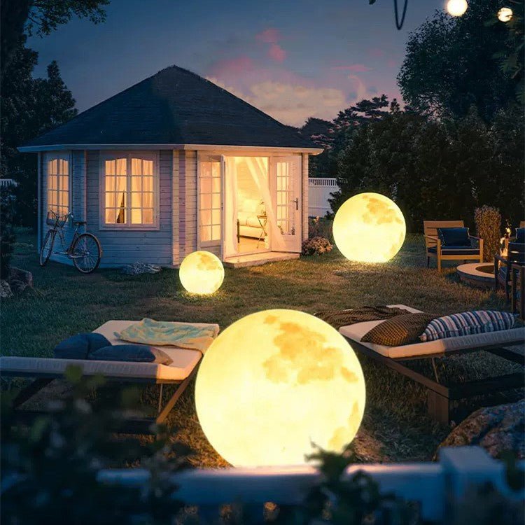 3D Moon Indoor & Outdoor Floor Lamp glowing warmly in a backyard setting, perfect for indoor and outdoor ambiance.