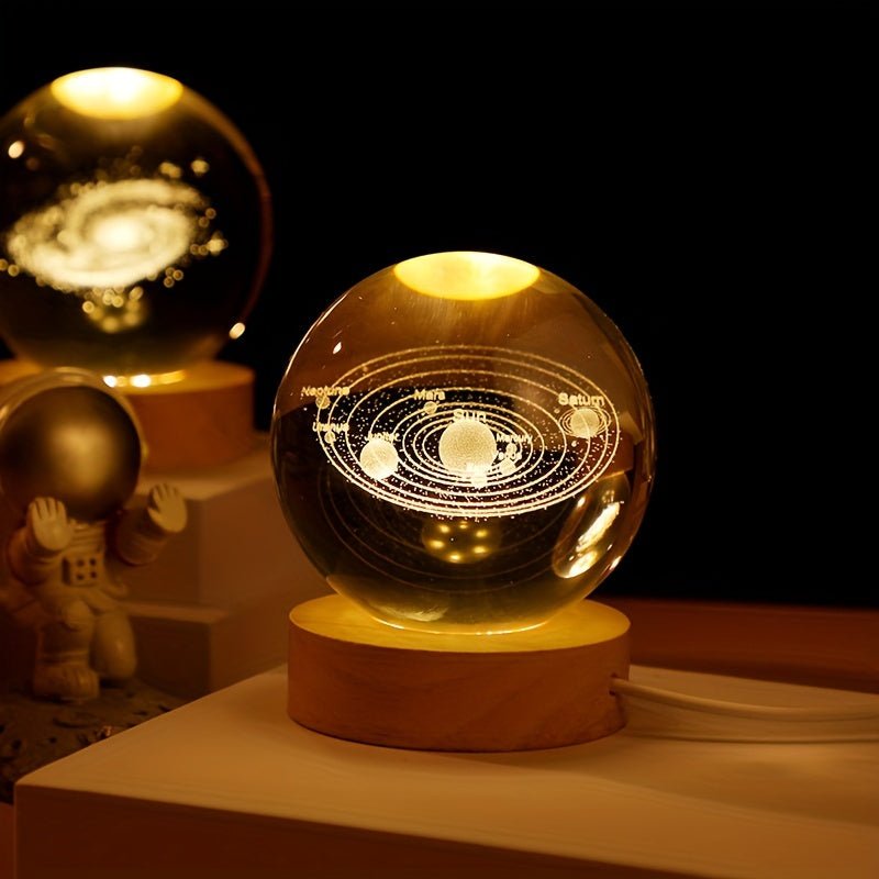3D Solar System Crystal Ball Light with laser-etched planets illuminated by warm LED on wooden base, perfect space decor.