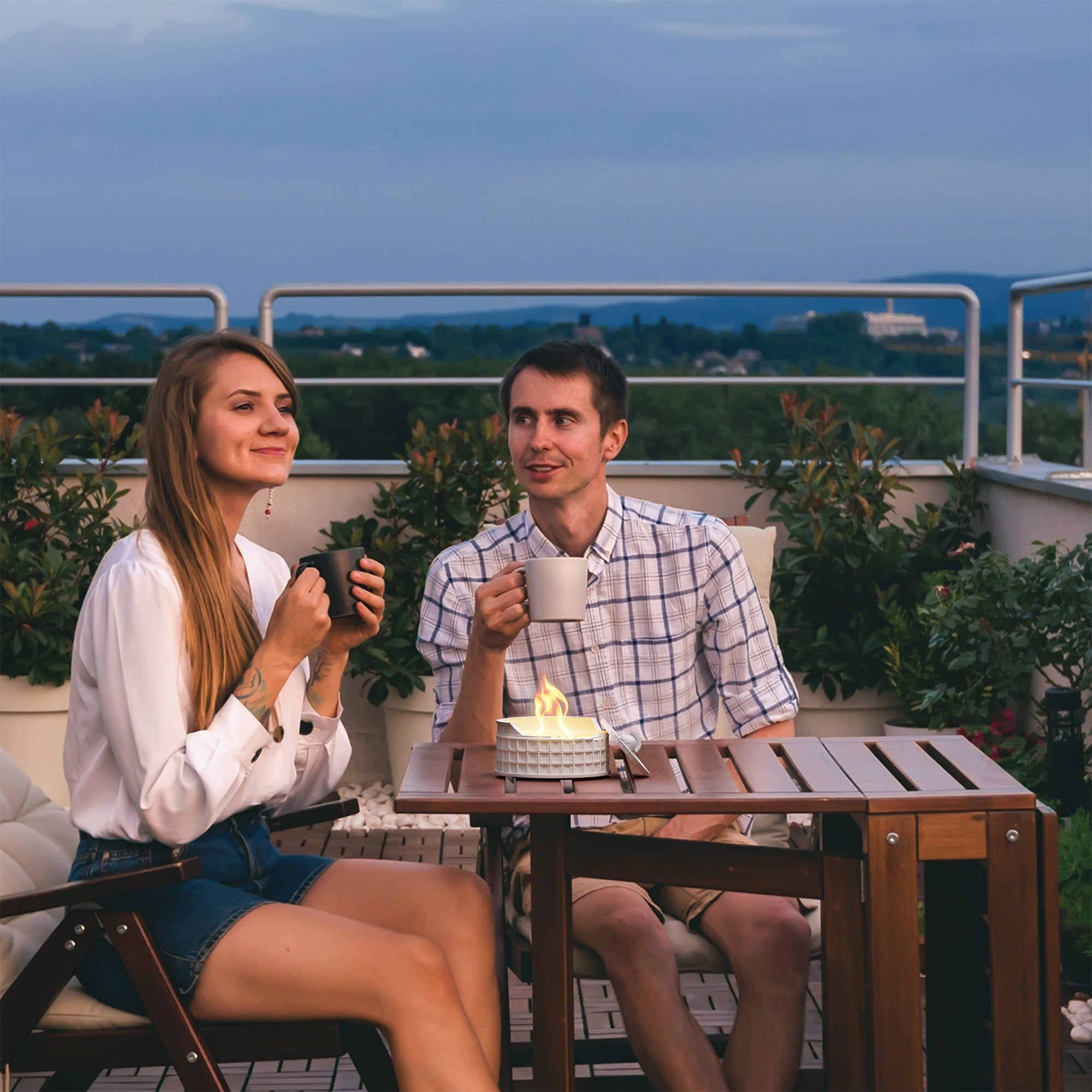 Couple enjoying cozy evening on patio with Colosseum Tabletop Fire Pit providing smokeless warmth and ambiance.