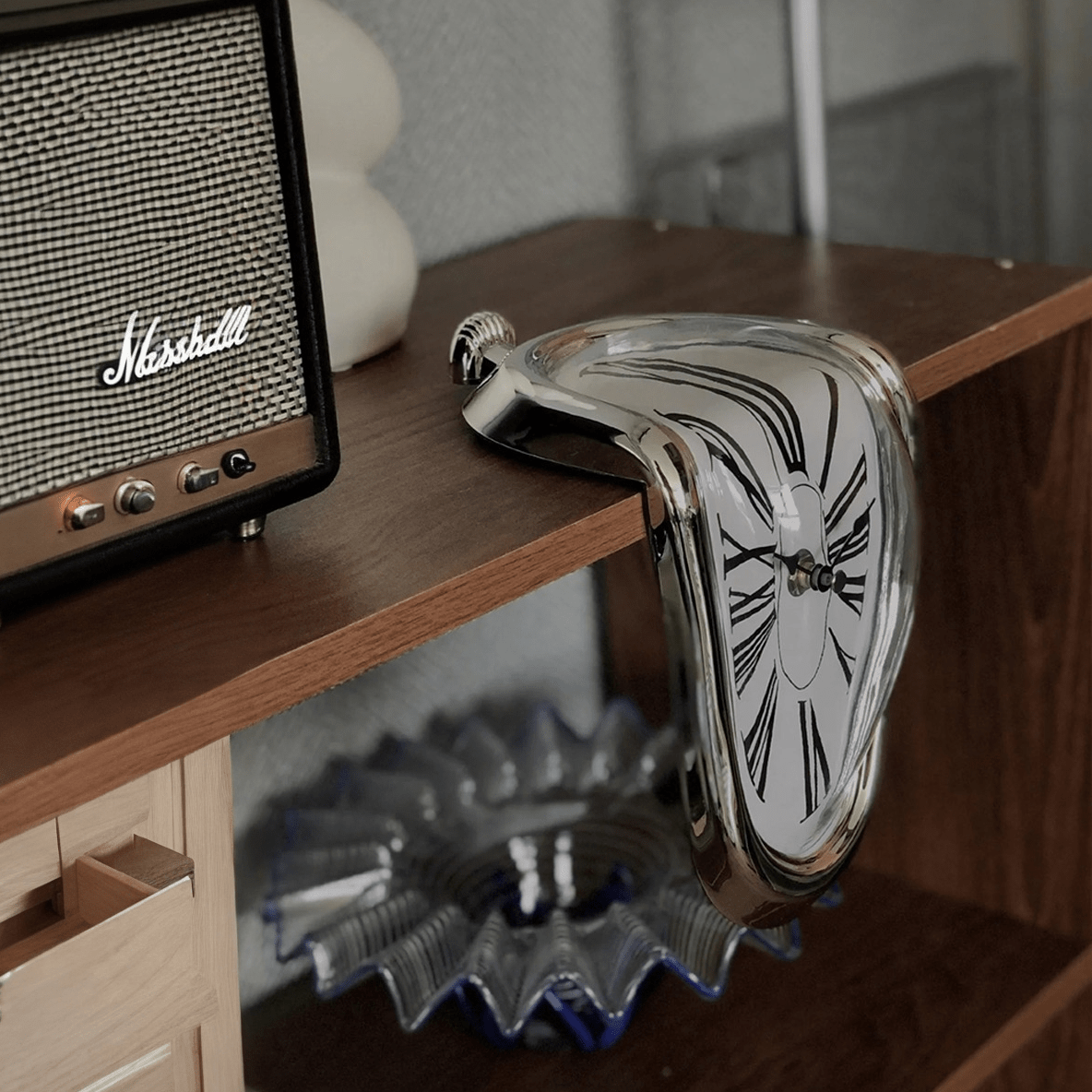 DALI Melting Clocks (2-Pack) surrealist silver clock bending over shelf edge, inspired by Persistence of Memory.