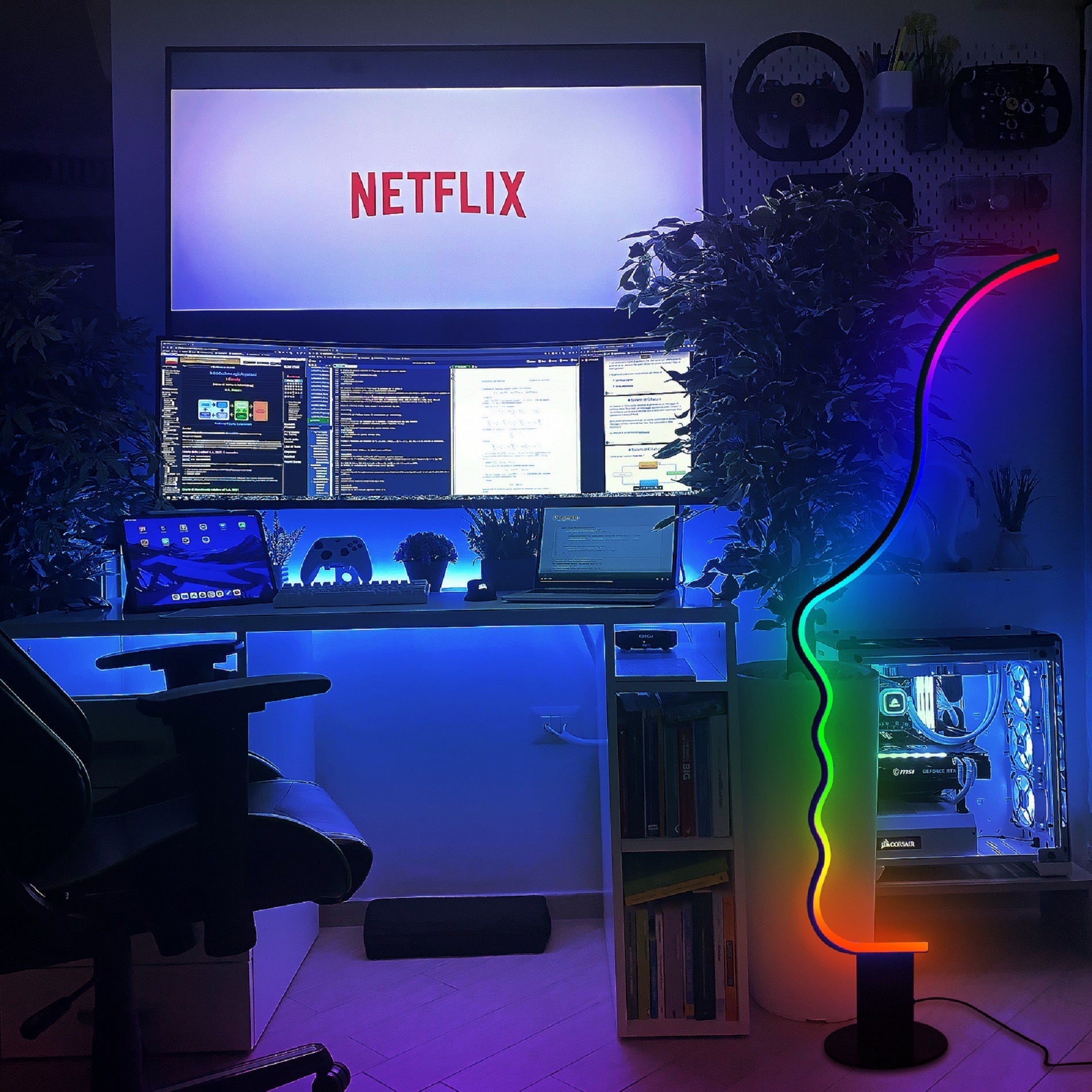 Edward Visage RGB Lamp illuminating a modern gaming and work setup with vibrant customizable LED colors.