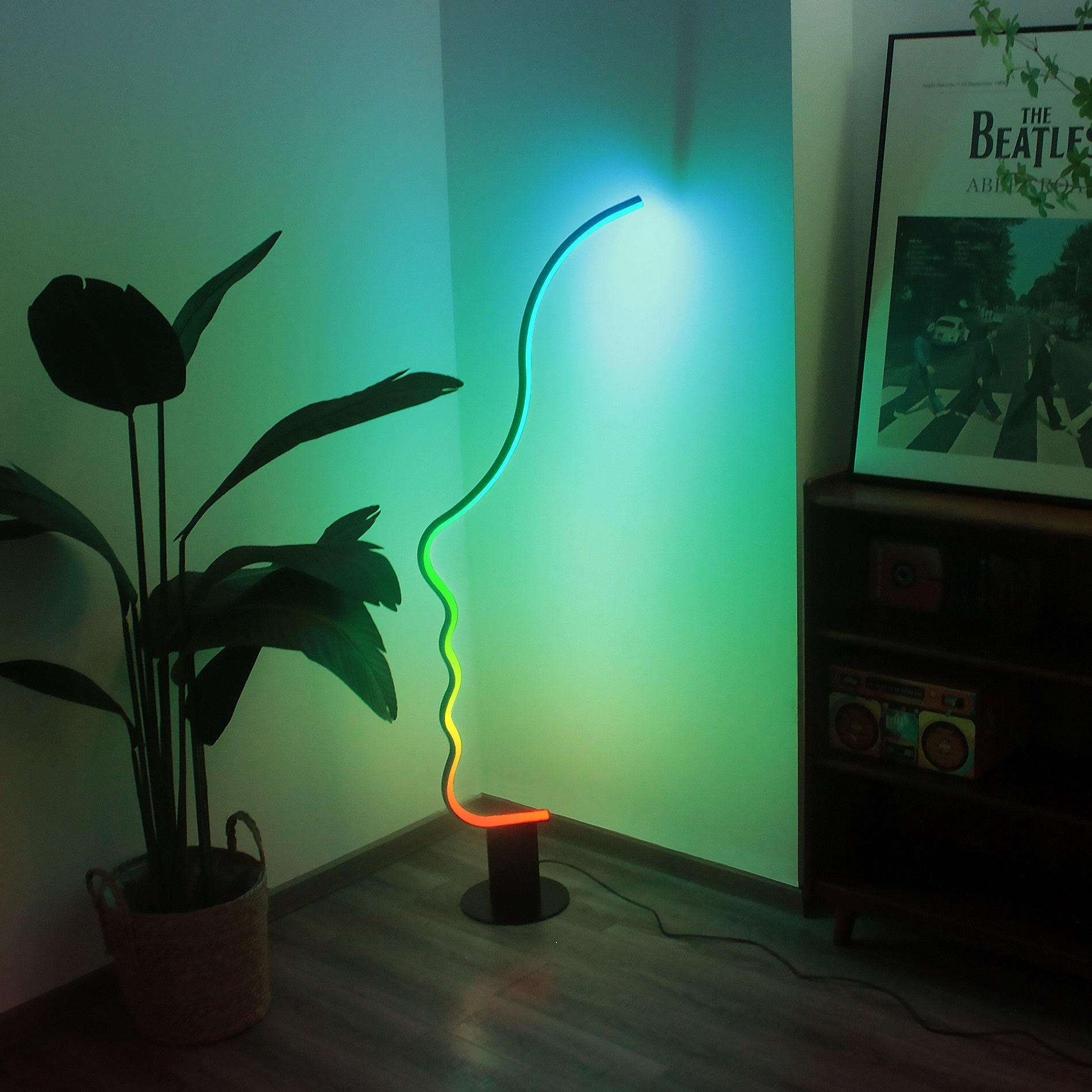Edward Visage RGB Lamp glowing in vibrant colors, modern sculptural floor lamp adding artistic ambient lighting.