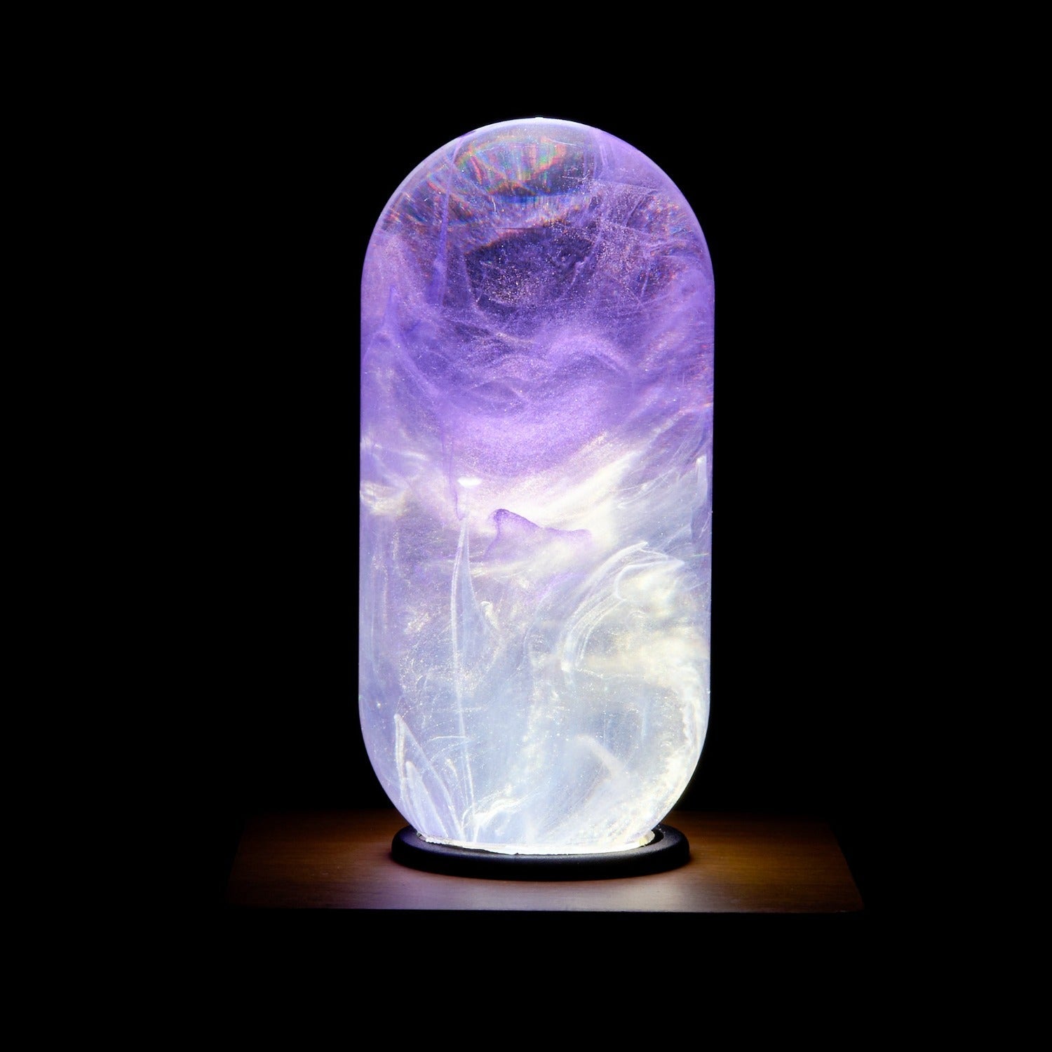 EP Light - Amethyst bulb glowing with unique handcrafted purple and white resin design on wooden base.