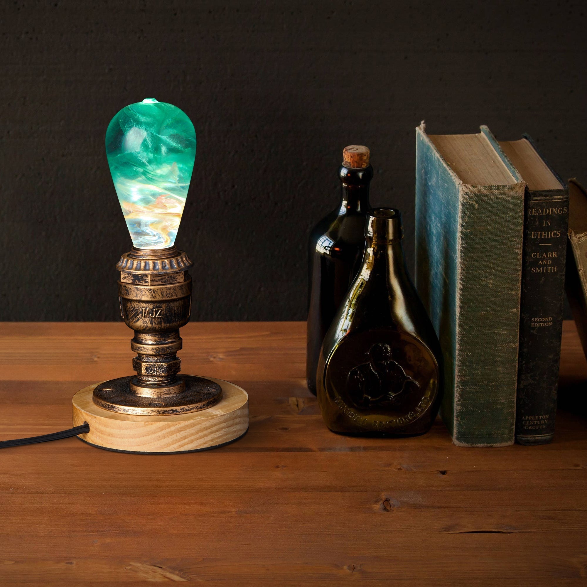 EP Light - Aquaria lamp with unique ocean-inspired resin bulb on rustic wooden base beside vintage books and bottles.