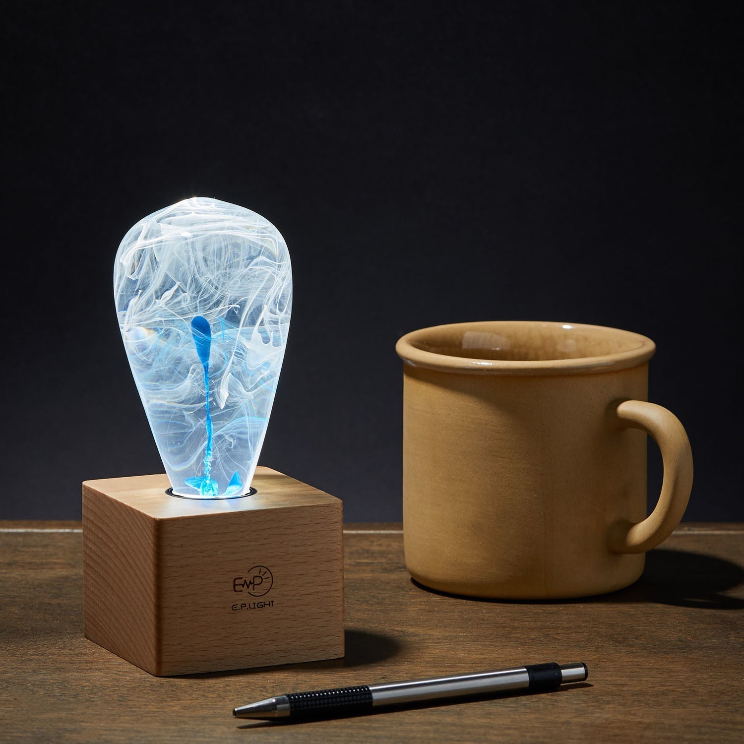 EP Light - Blue Drop handcrafted blue LED lamp on wooden base, creating a soothing and unique ambient light.