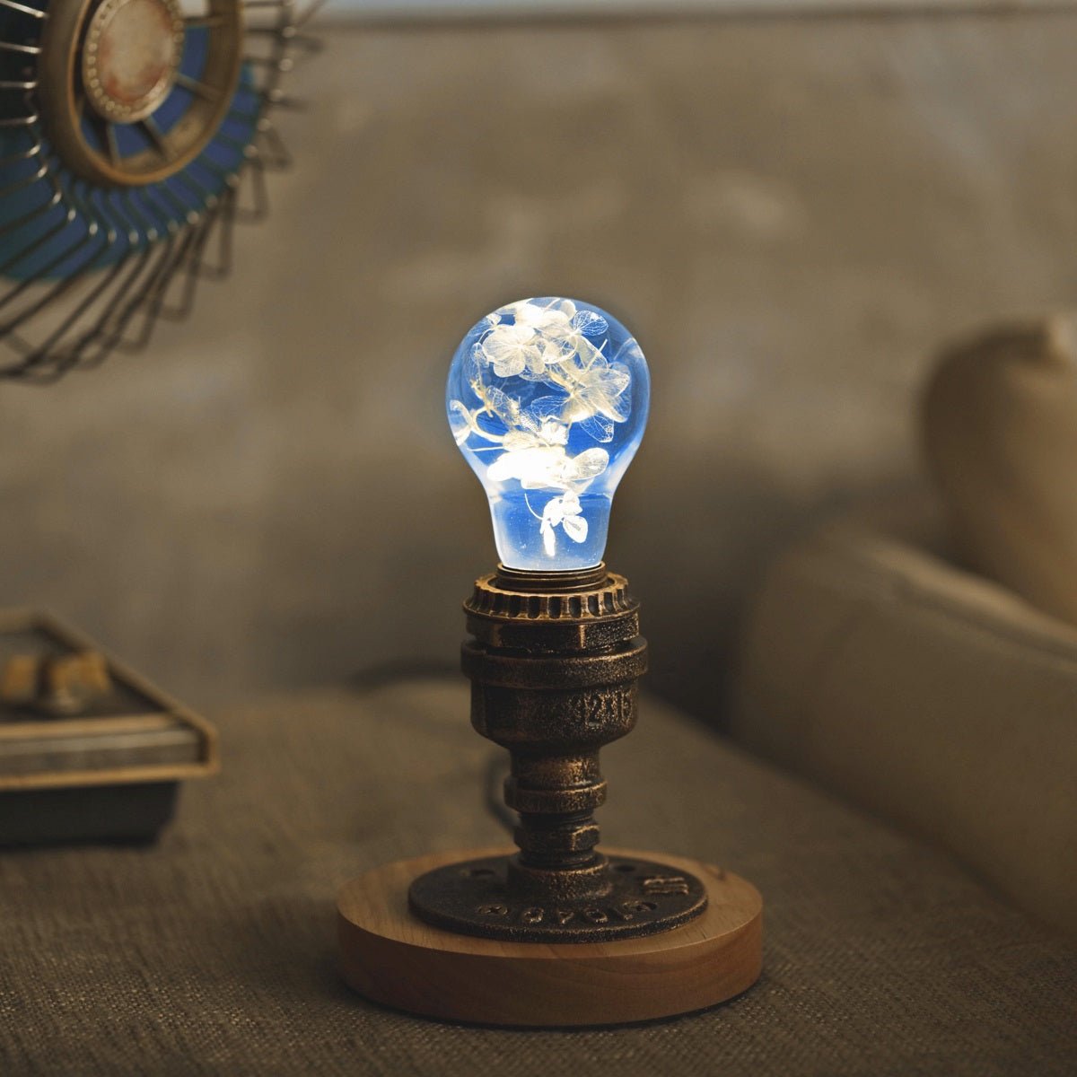 EP Light- Blue Hydrangea handcrafted bulb with eco-friendly resin and vibrant blue floral design lighting a cozy room.