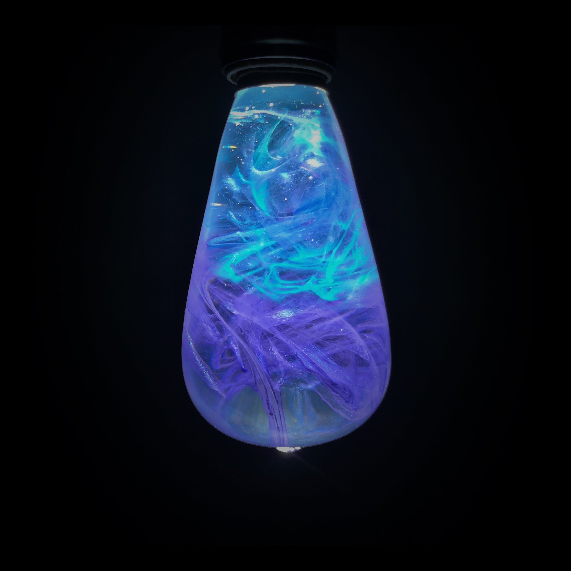 EP Light - Faith bulb glowing with vivid blue and purple resin swirls, handcrafted unique artistic LED lighting.