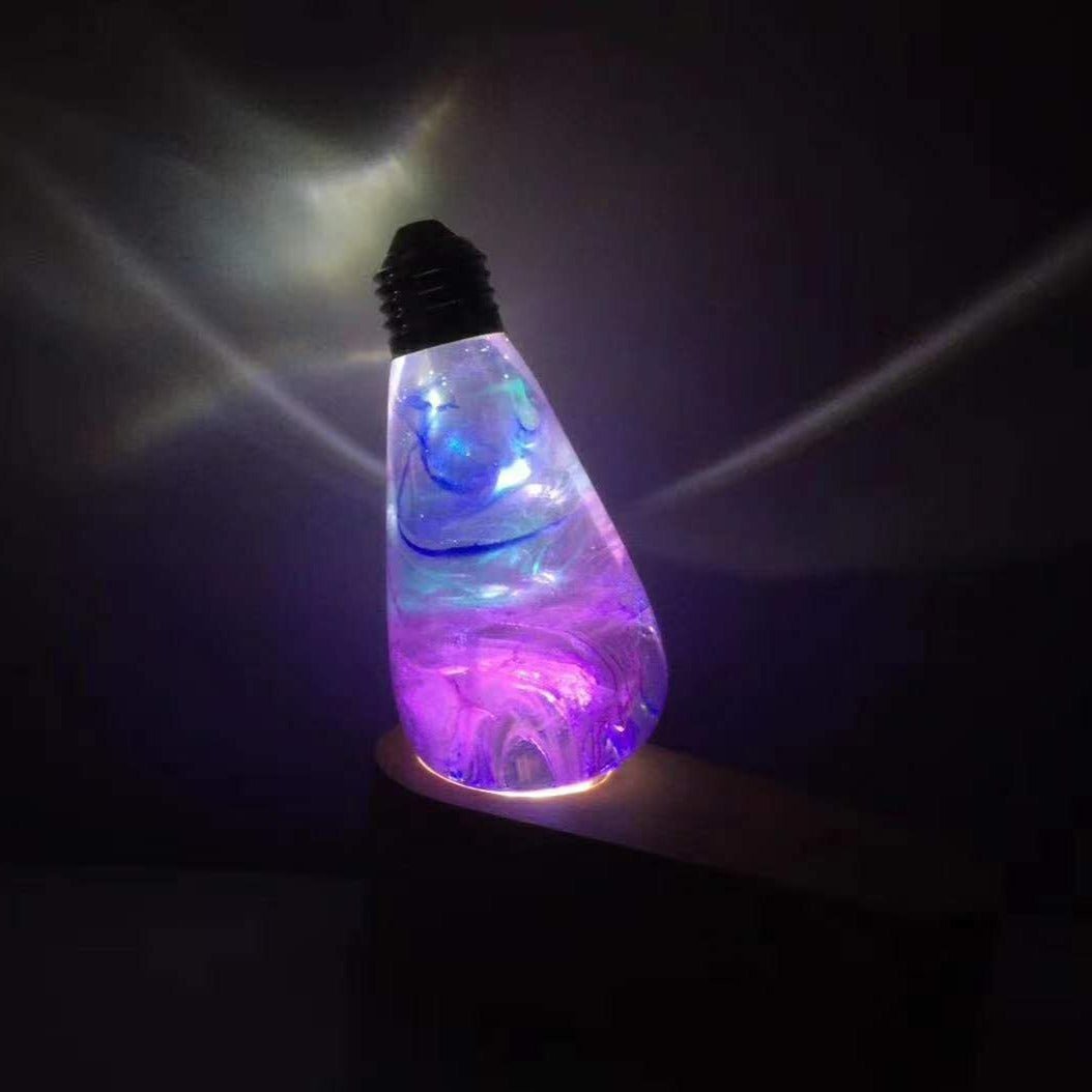 EP Light - Faith bulb glowing with vivid resin colors, designed for E26/E27 sockets, unique and energy-efficient LED lighting.