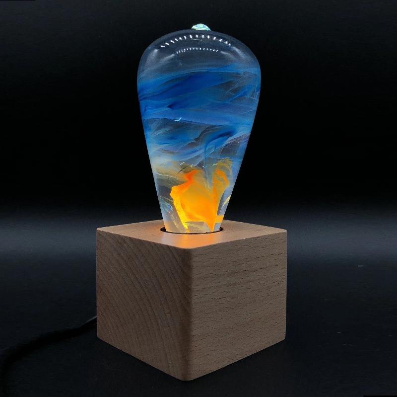 EP Light - Fire LED bulb with unique blue and amber flame effect on a wooden base, handcrafted and drop-resistant.