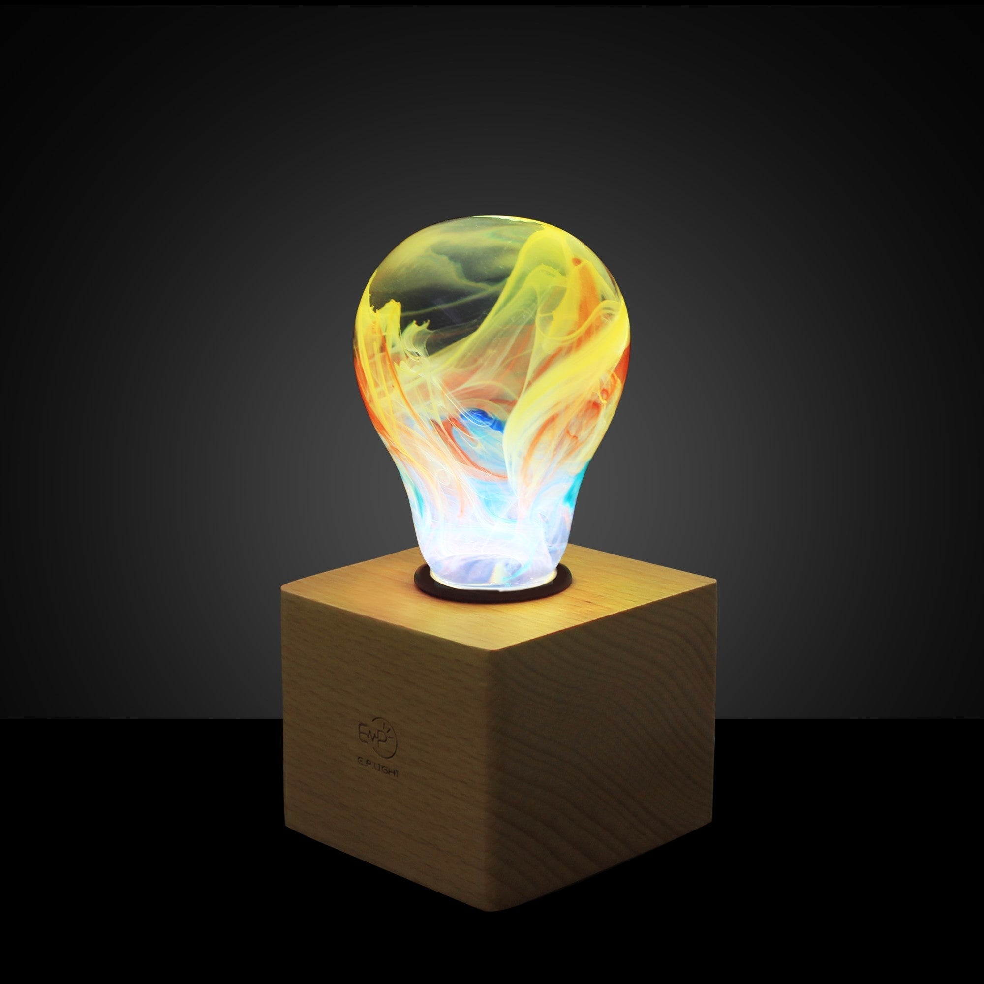 EP Light - Firework bulb glowing with vibrant, unique colors on wooden base, adding dazzling handcrafted brilliance to any space.