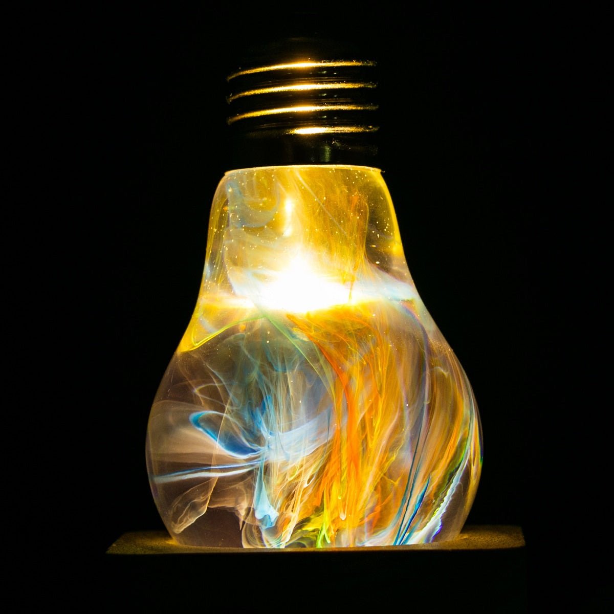 EP Light - Firework bulb glowing with vibrant, unique handcrafted color patterns made from durable eco-resin.