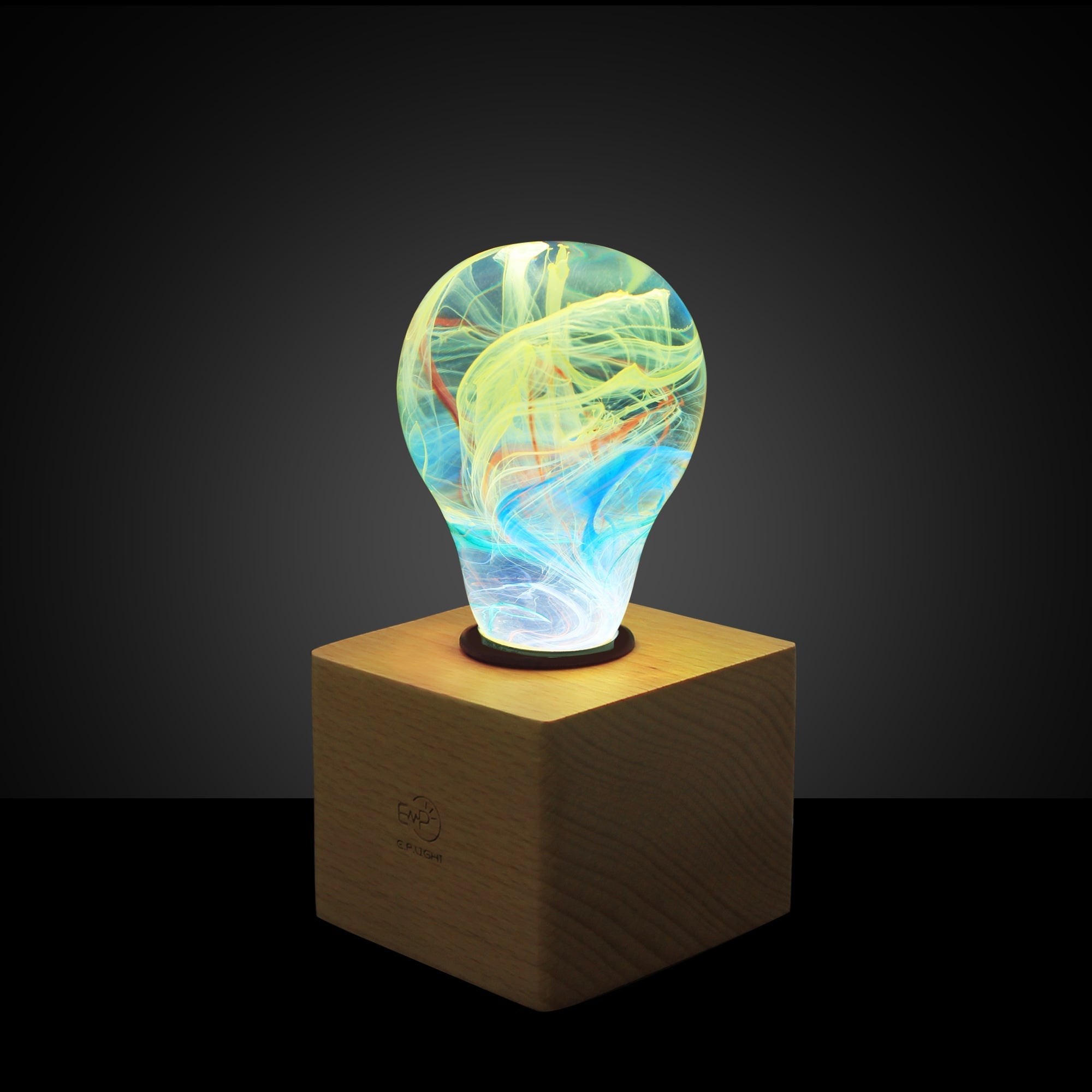EP Light - Firework bulb glowing with vibrant, unique color patterns on a wooden base, handcrafted and eco-friendly design.
