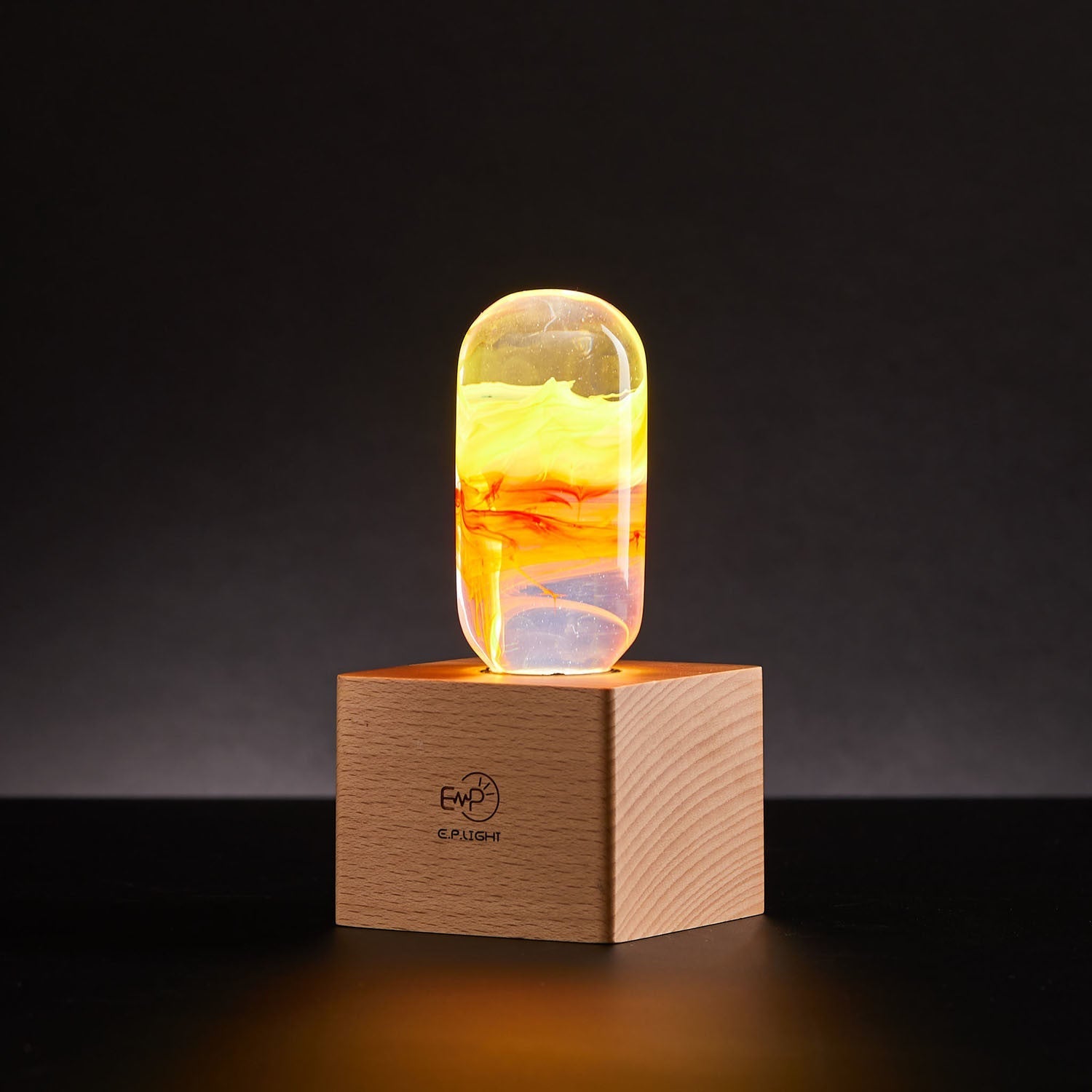 EP Light - Flame bulb glowing with fiery amber hues on a wooden base, handcrafted safe-to-touch LED decor.