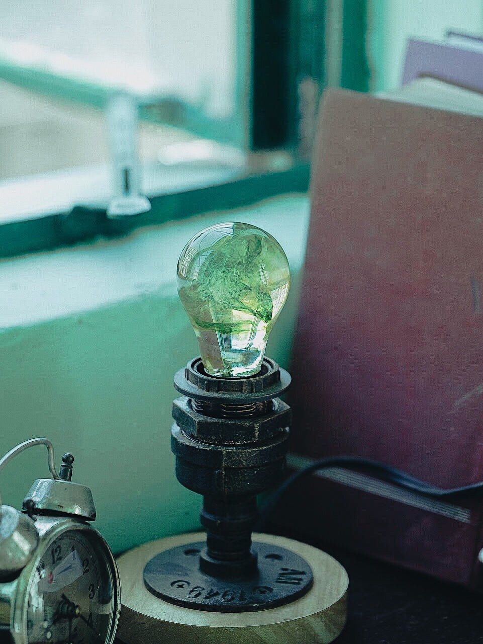 EP Light - Galaxy bulb with unique green galactic swirls, wooden base, eco-friendly resin, glowing day and night.