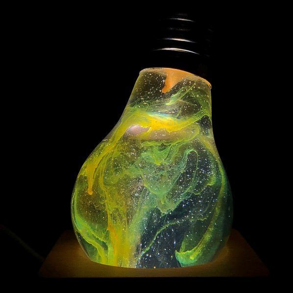 EP Light - Galaxy bulb glowing with unique galactic swirls in eco-friendly resin, fits E26/E27 sockets with wooden base options.