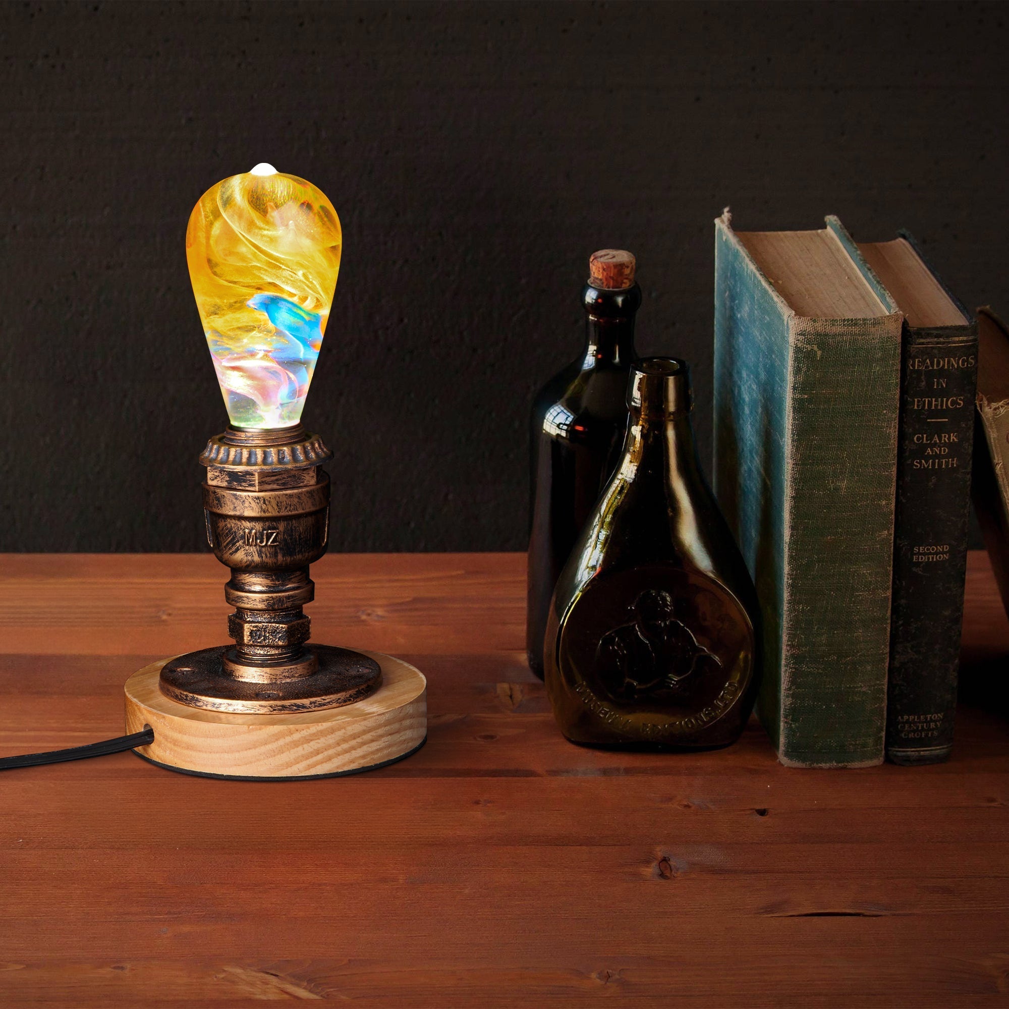 EP Light - Garden handcrafted eco-resin LED bulb glowing warmly on rustic wooden base beside vintage books and bottles