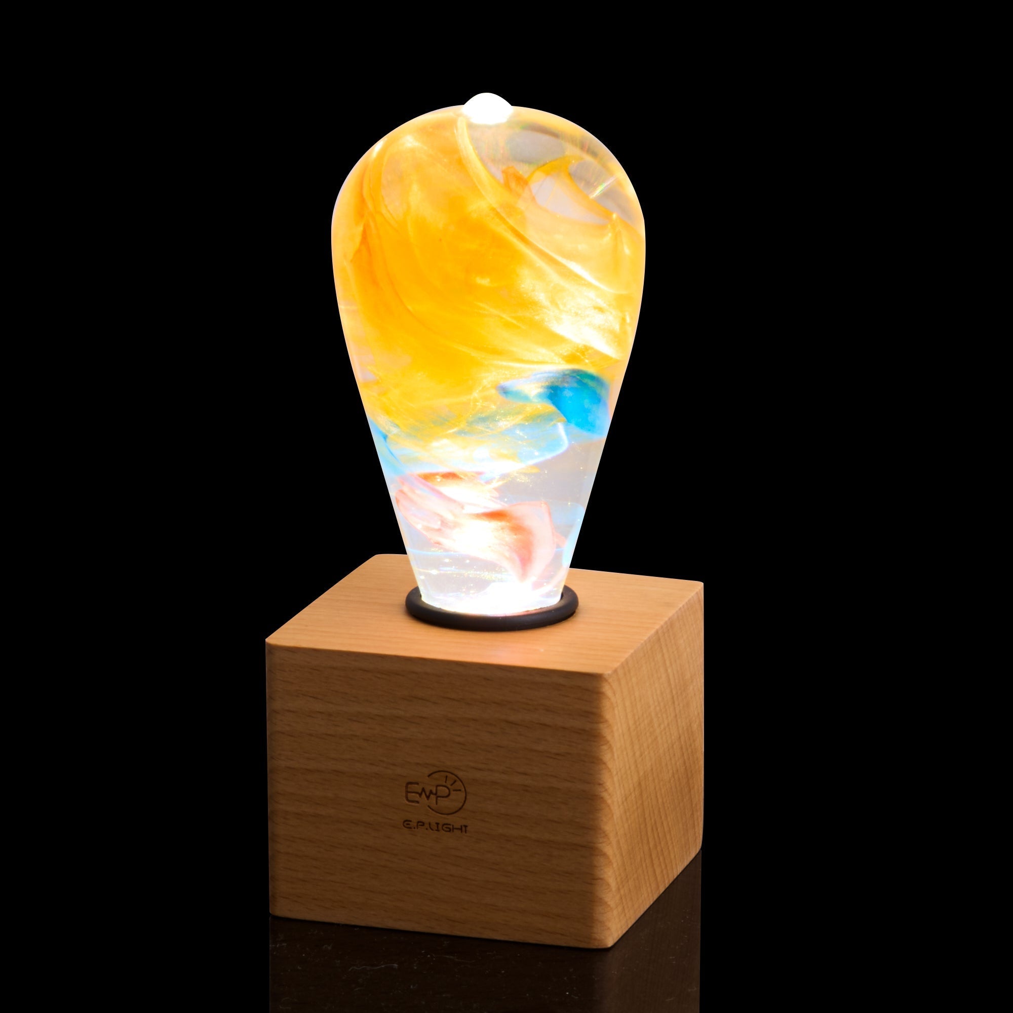 EP Light - Garden glowing handcrafted eco-resin LED bulb with vibrant colors on wooden base for natural home decor.