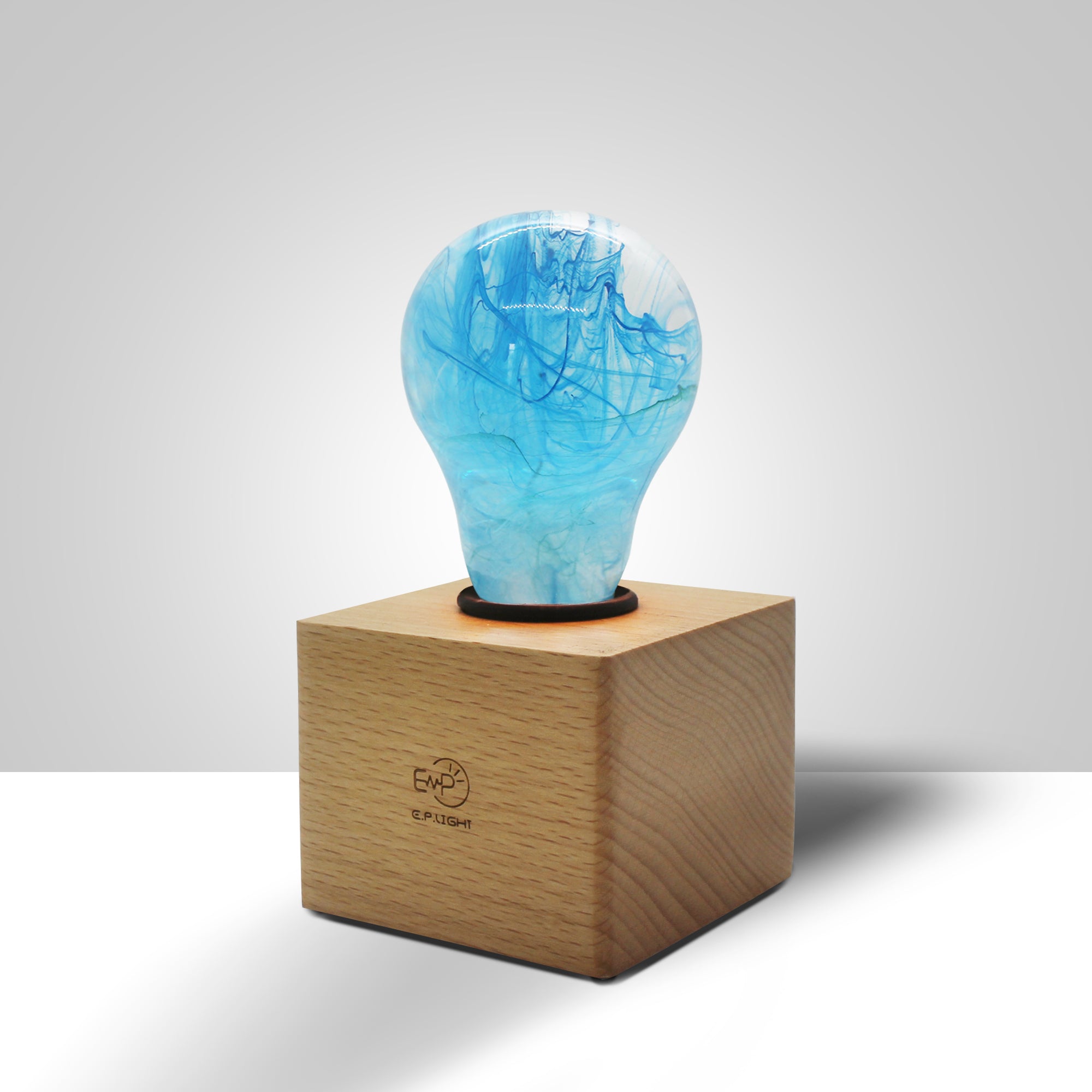 EP Light - Memory bulb with unique blue swirl design on a vintage wooden base, energy-efficient and handcrafted.