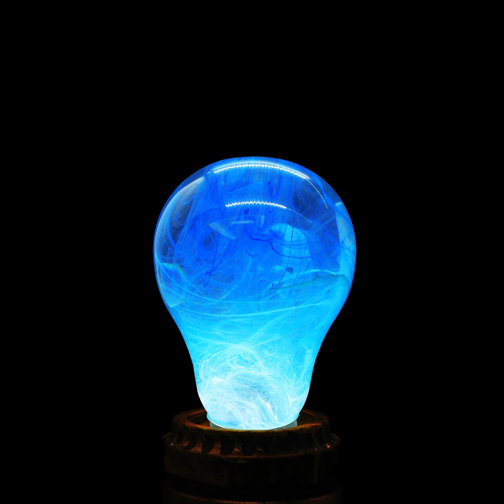 EP Light - Memory bulb glowing with unique blue swirl design on vintage wooden base, eco-friendly and energy-saving.