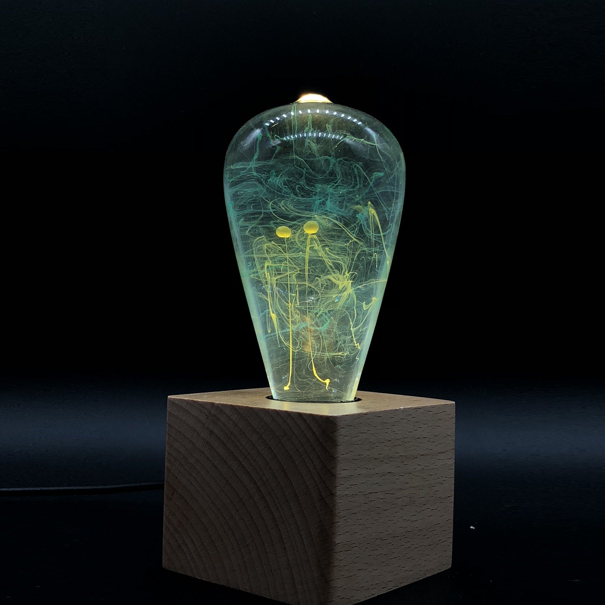 EP Light - Mind lamp glowing with unique eco-resin design on wooden base, inspiring calm and creativity.