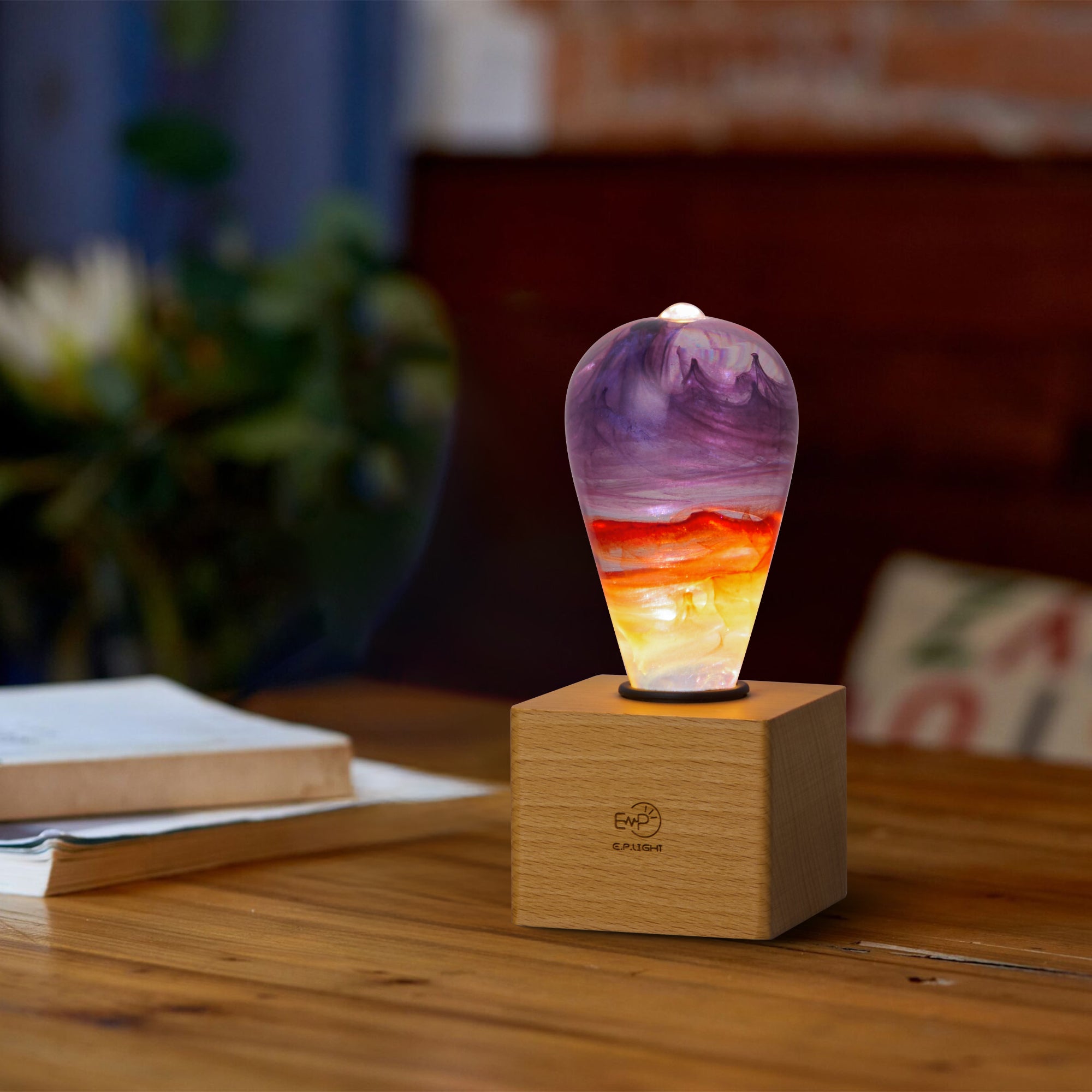 EP Light - Passion handcrafted eco-resin bulb with vibrant colors on wooden base, radiating creative, energy-efficient light.