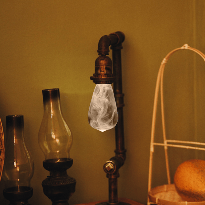 EP Light - Snow bulb with handcrafted resin design emits calming winter-inspired glow in vintage-style lamp setup.