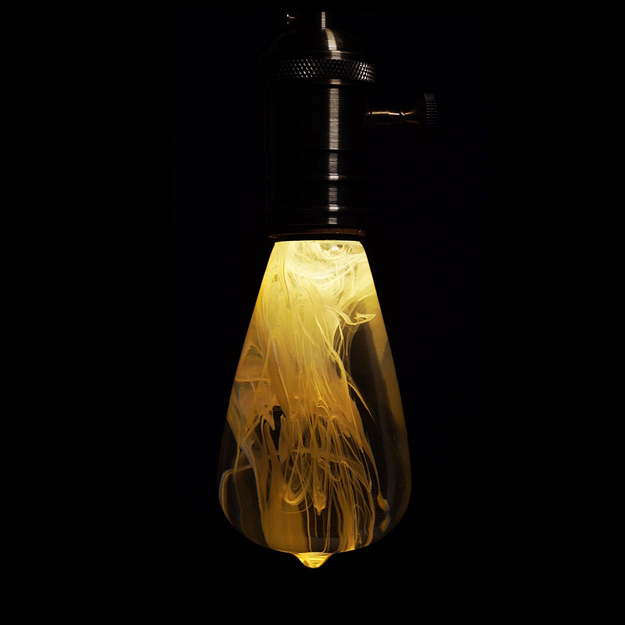 EP Light - Snow bulb glowing softly with handcrafted swirling interior patterns for calming, energy-saving lighting.