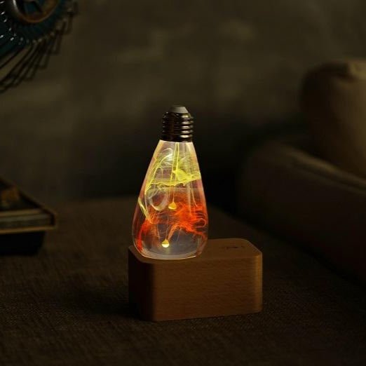 EP Light - Solar Corona handcrafted LED lamp with celestial solar halo design casting warm radiant glow on wooden base.