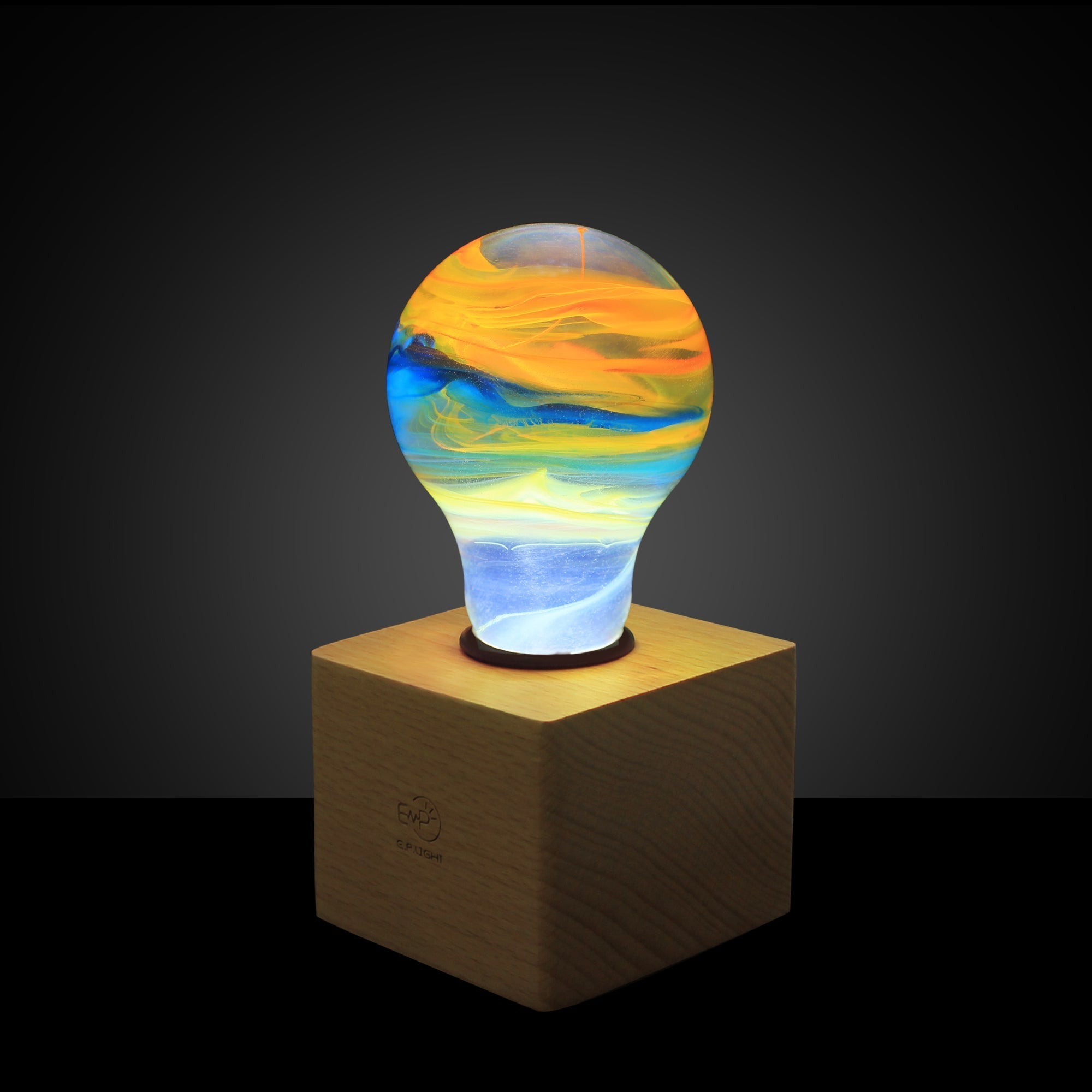 EP Light - Solar System bulb glowing with unique colorful cosmic patterns on wooden stand, handcrafted and eco-friendly lighting.