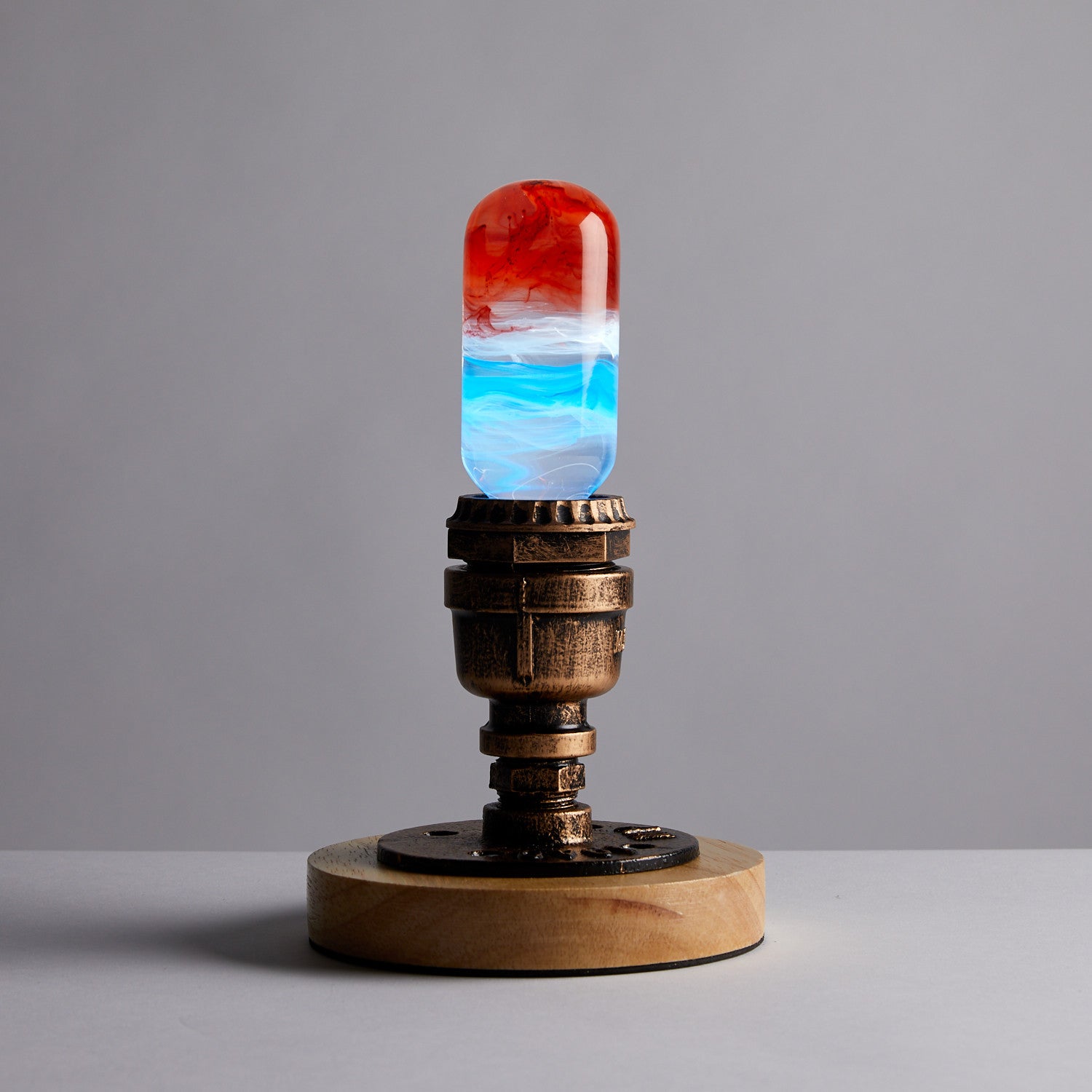 EP Light - Sunrise handcrafted LED bulb with vibrant sunrise colors in eco-friendly resin on unique metal and wood base.
