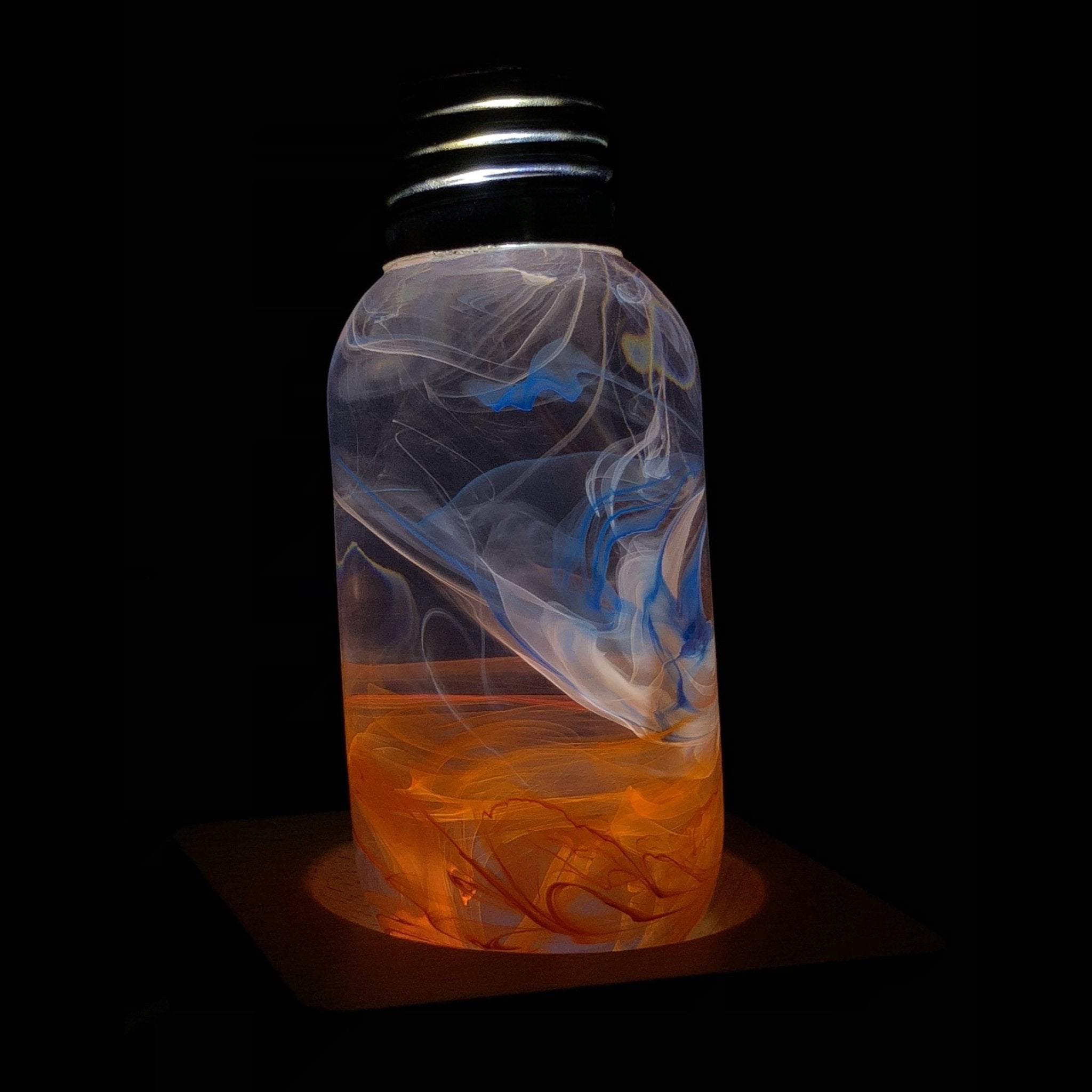 EP Light - Sunrise bulb with unique sunrise-inspired resin design glowing warmly on black background.