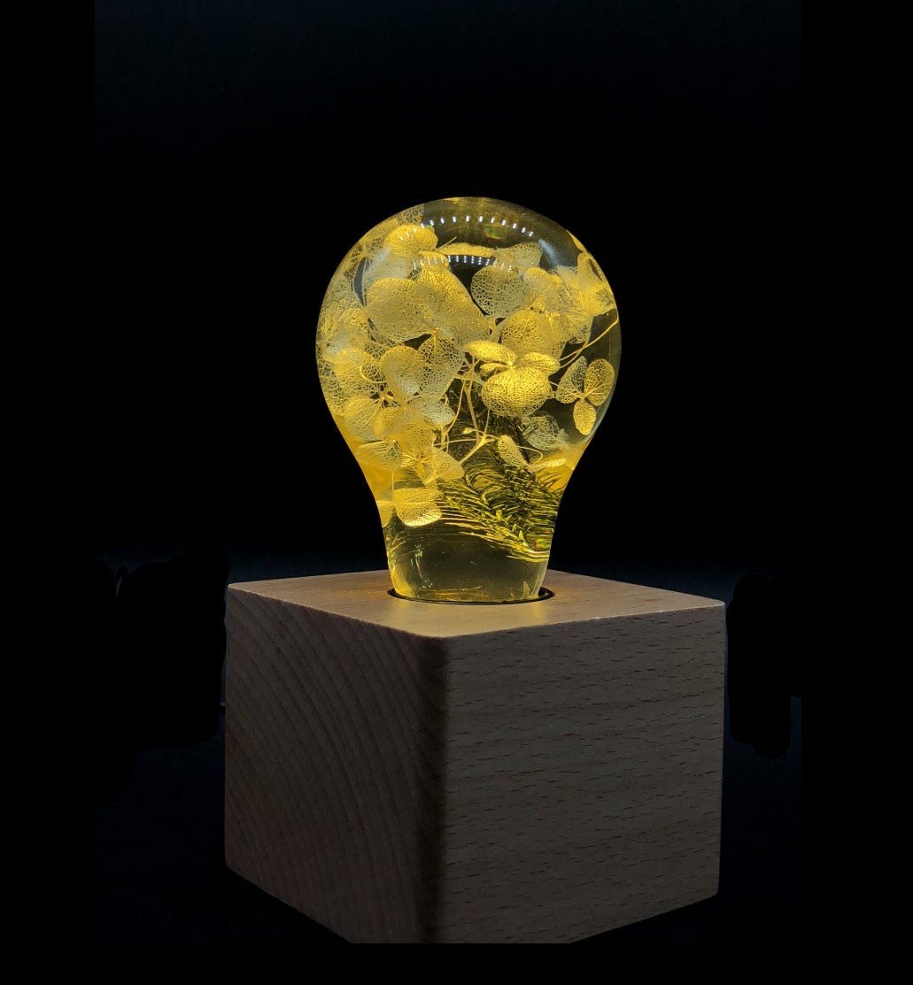 EP Light - Yellow Hydrangea handcrafted LED bulb glowing warmly with unique floral patterns on wooden base