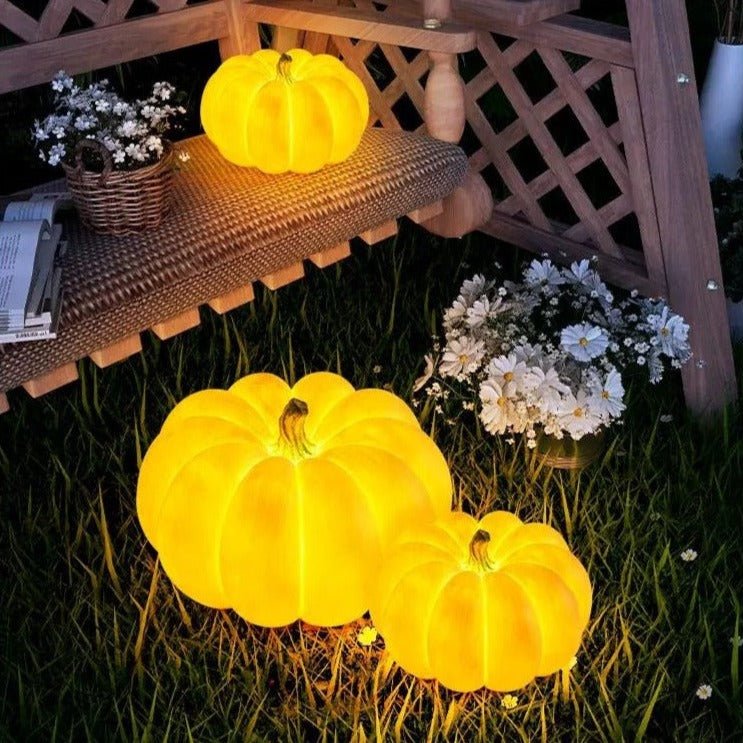 Indoor & Outdoor Pumpkin Lantern glowing warmly on porch and grass, perfect for durable festive fall decoration.
