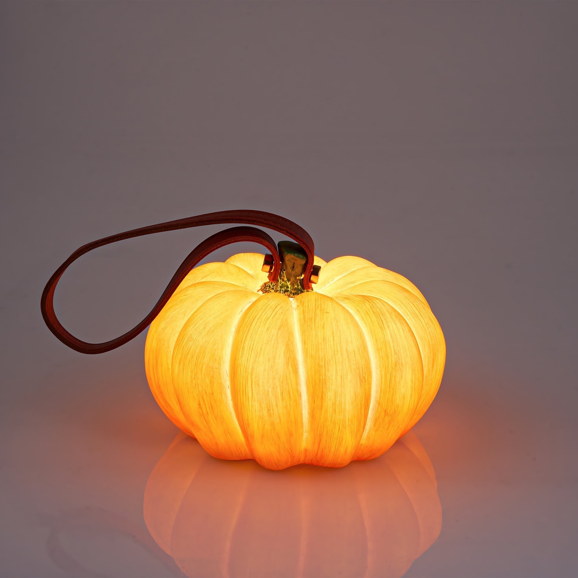 Indoor & Outdoor Pumpkin Lantern glowing warmly, durable and rechargeable for festive fall decor indoors or outdoors.
