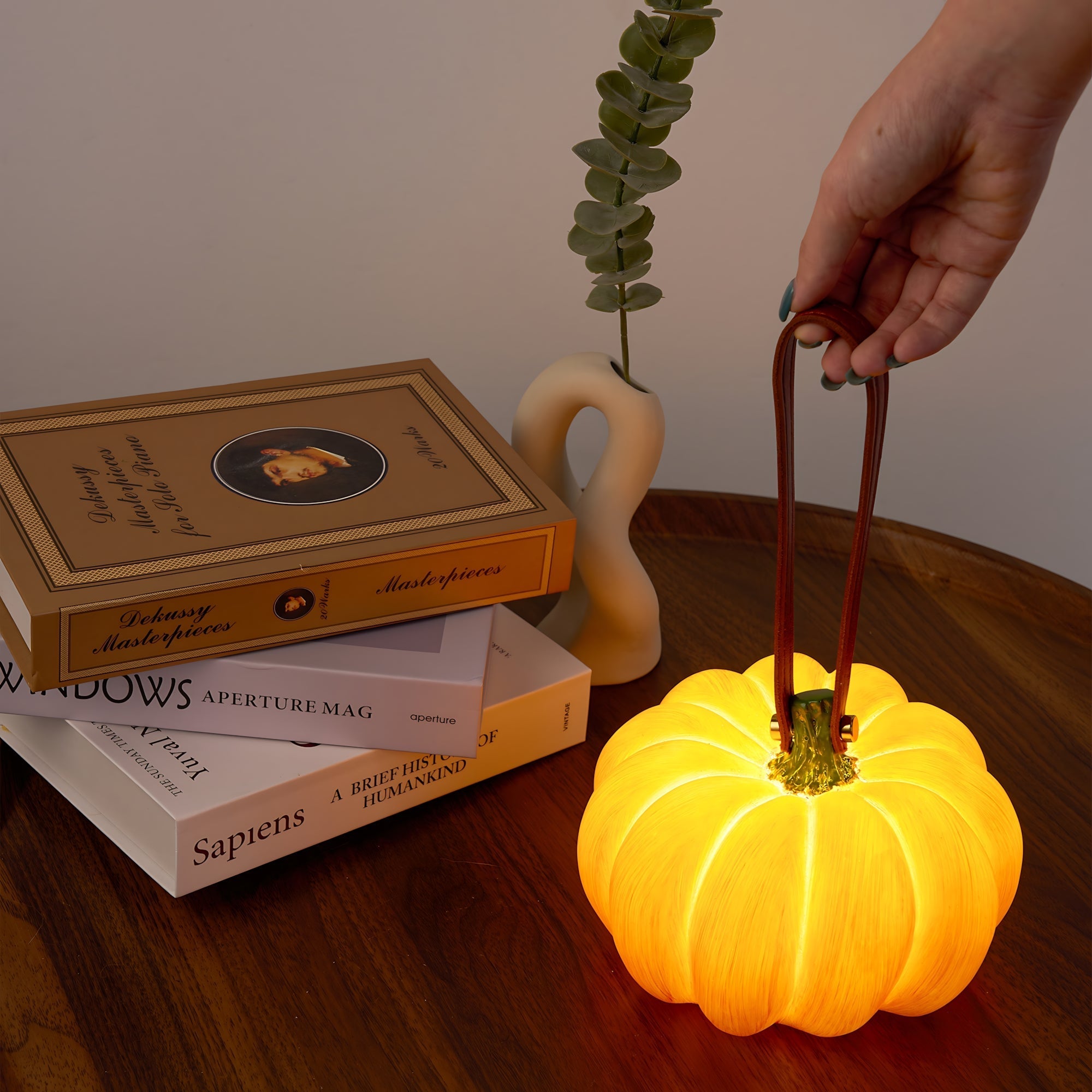 Indoor & Outdoor Pumpkin Lantern glowing warmly, durable resin, rechargeable, perfect for autumn and Halloween decor.